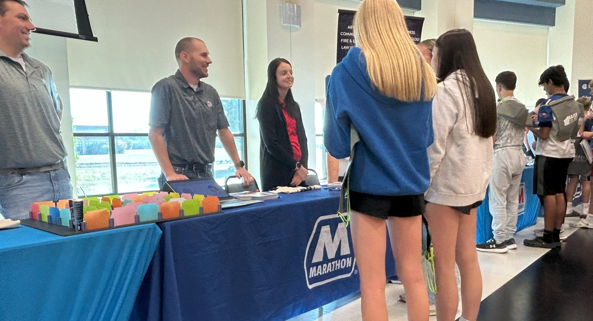 Middle school students gathered at an event booth during Raise the Bar's Career Connections day.