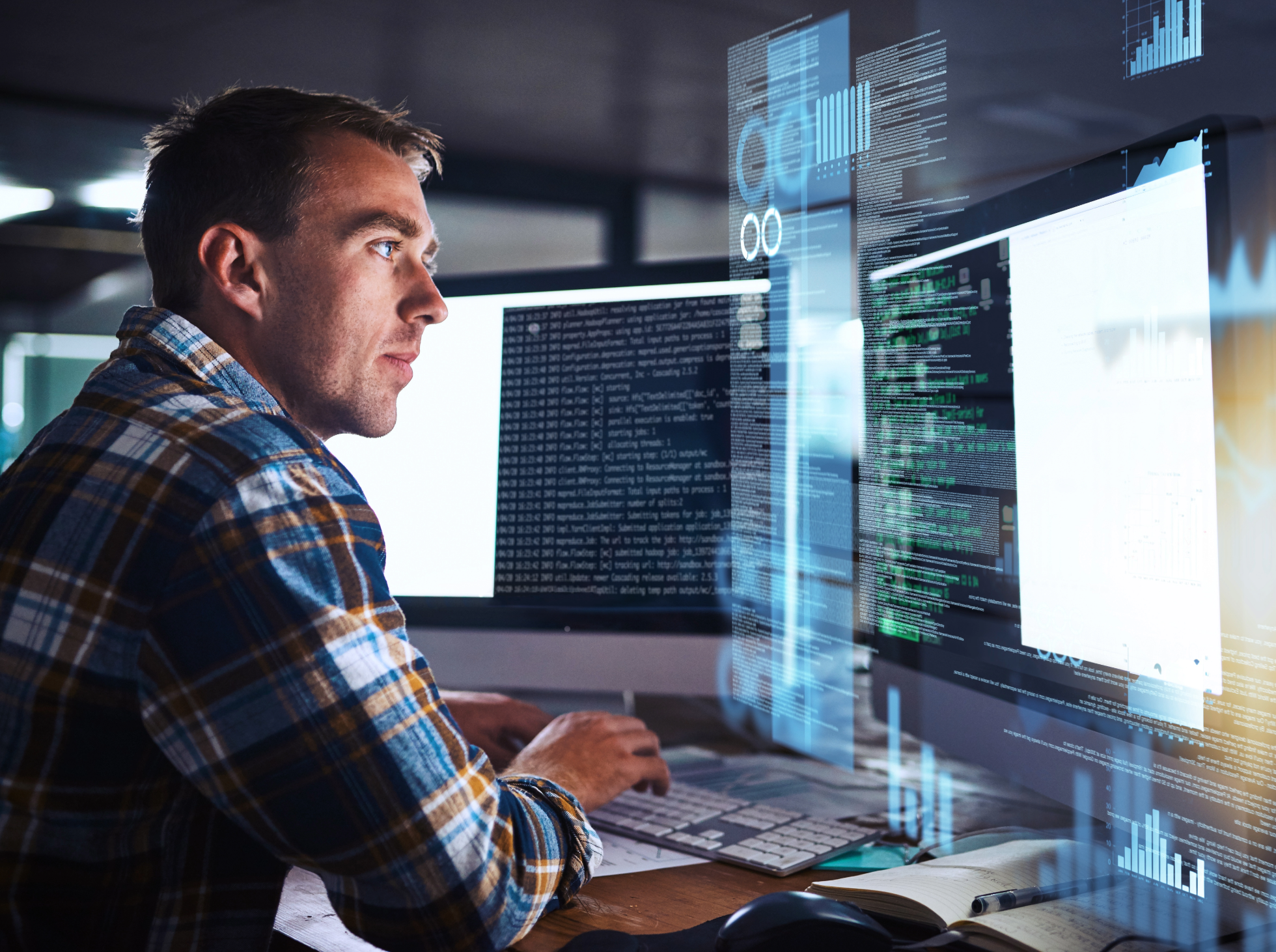 A man working on a computer with data and code.