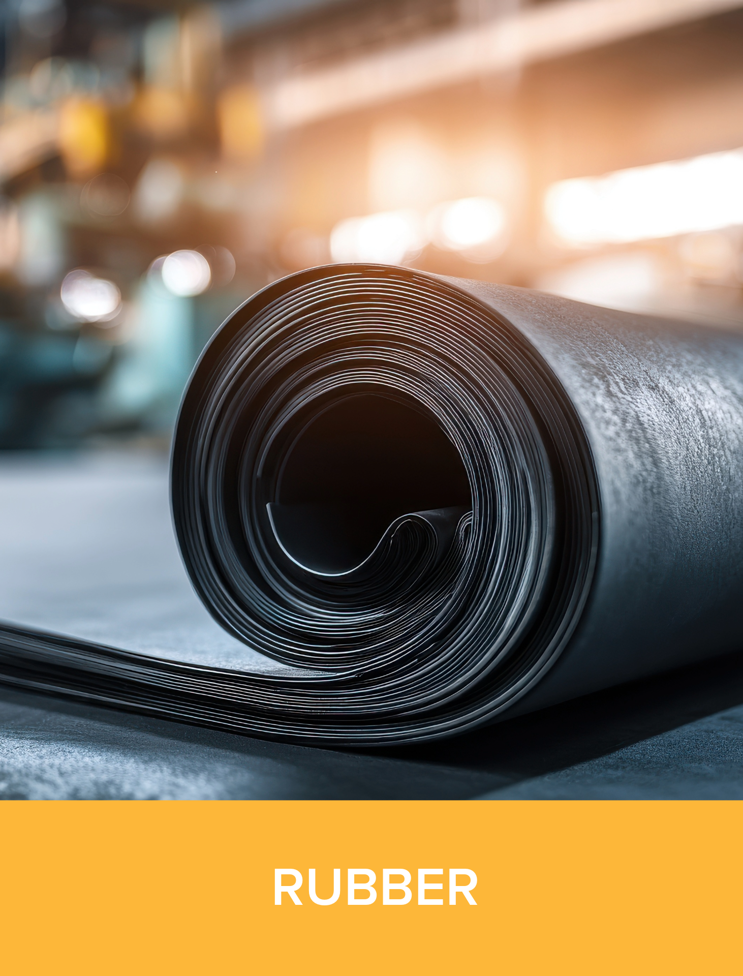Close-up of a rolled black rubber sheet in a factory.