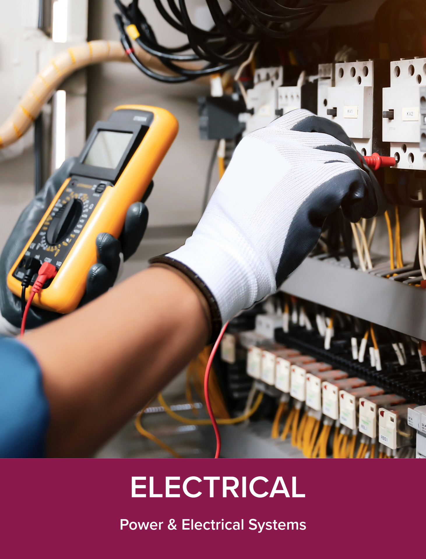 Person using a digital multimeter to test electrical wires in an electrical panel.