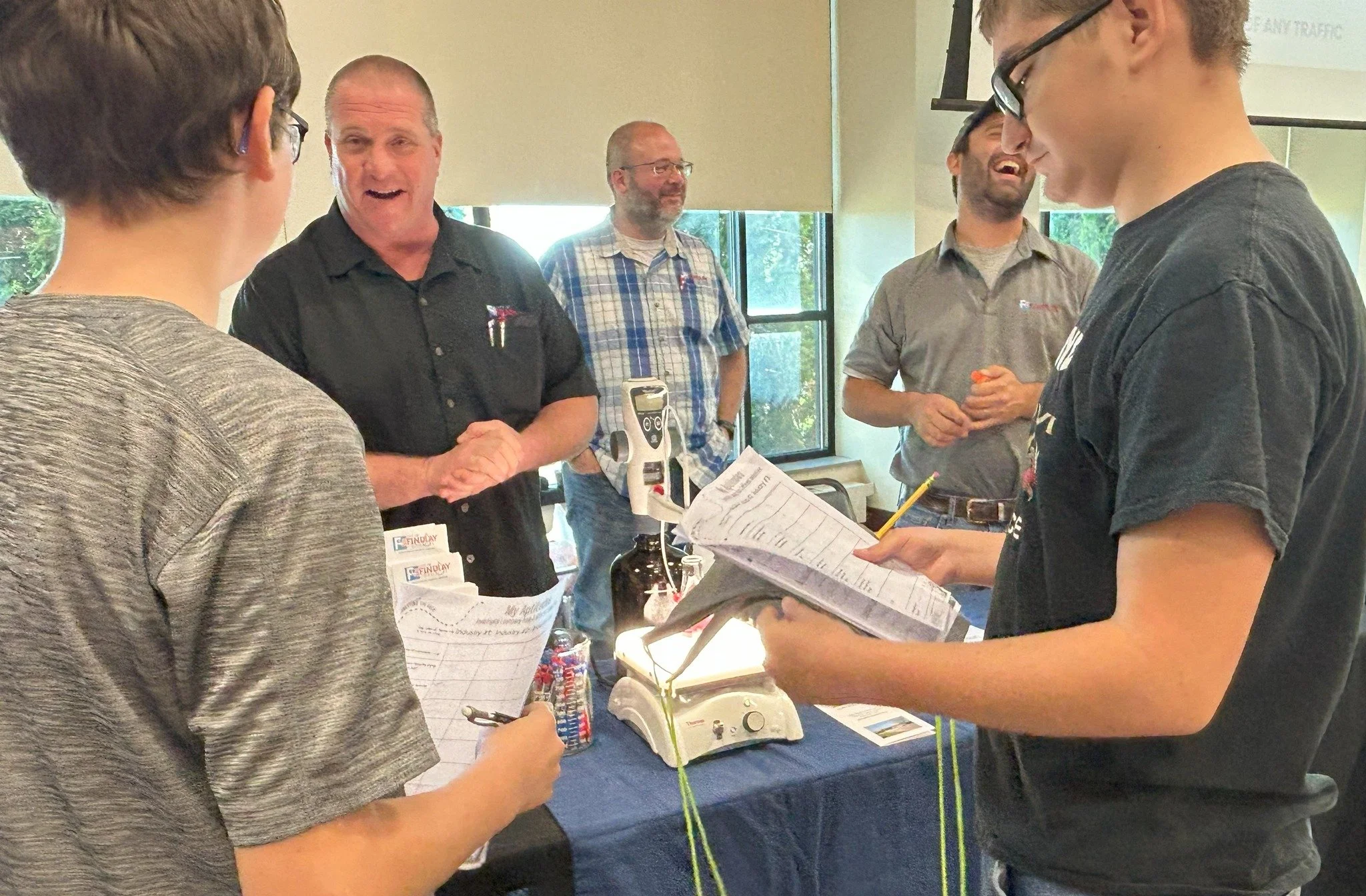 8th grade students interact with employees at Raise the Bar's Career Connections Day.