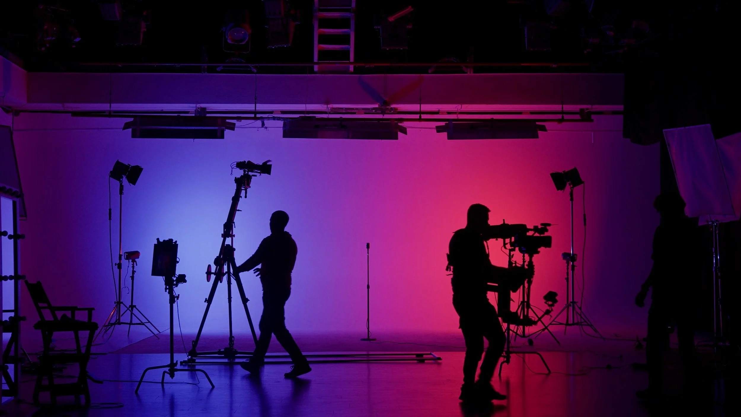 Silhouette of backstage workers on video production stage.