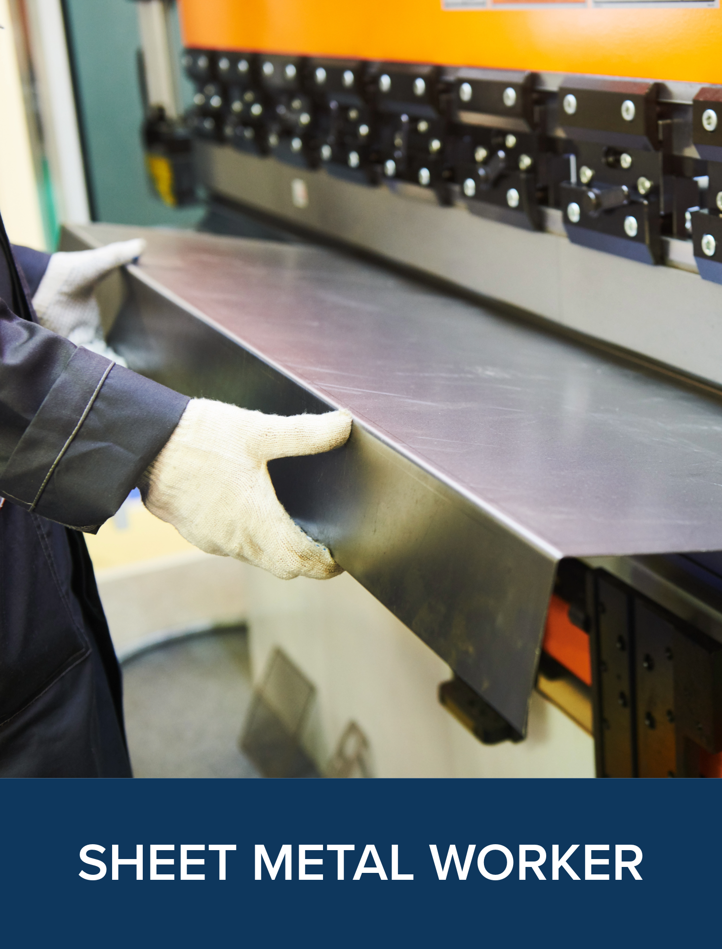 A sheet metal worker handling a large sheet of metal.