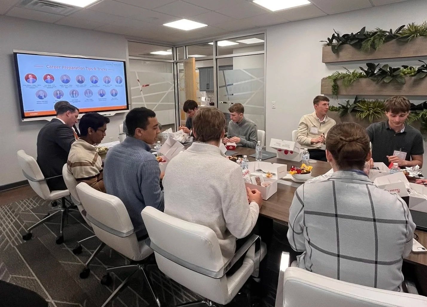 Students at board table at Hixon Zuercher Capital Management.