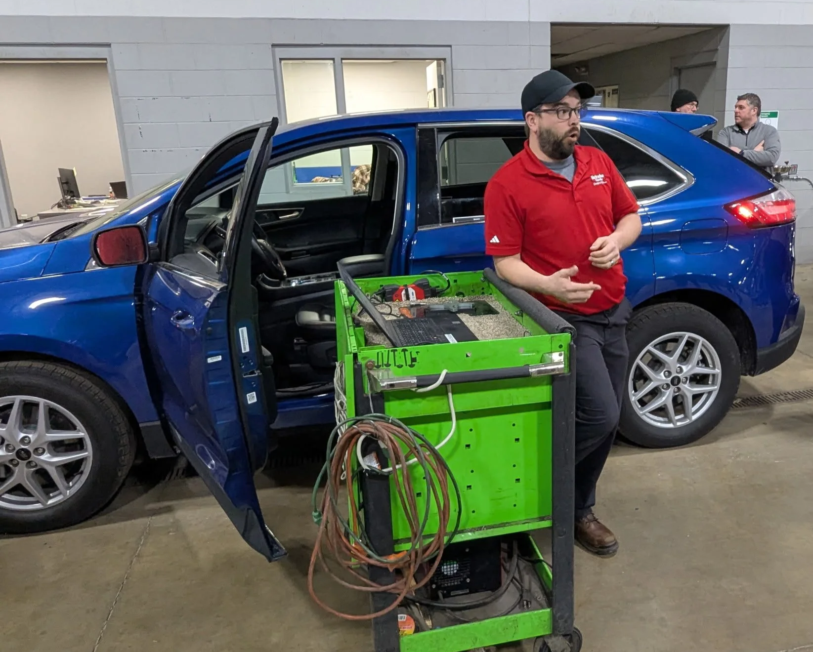 Reineke Ford employee discussing technology use on vehicles.