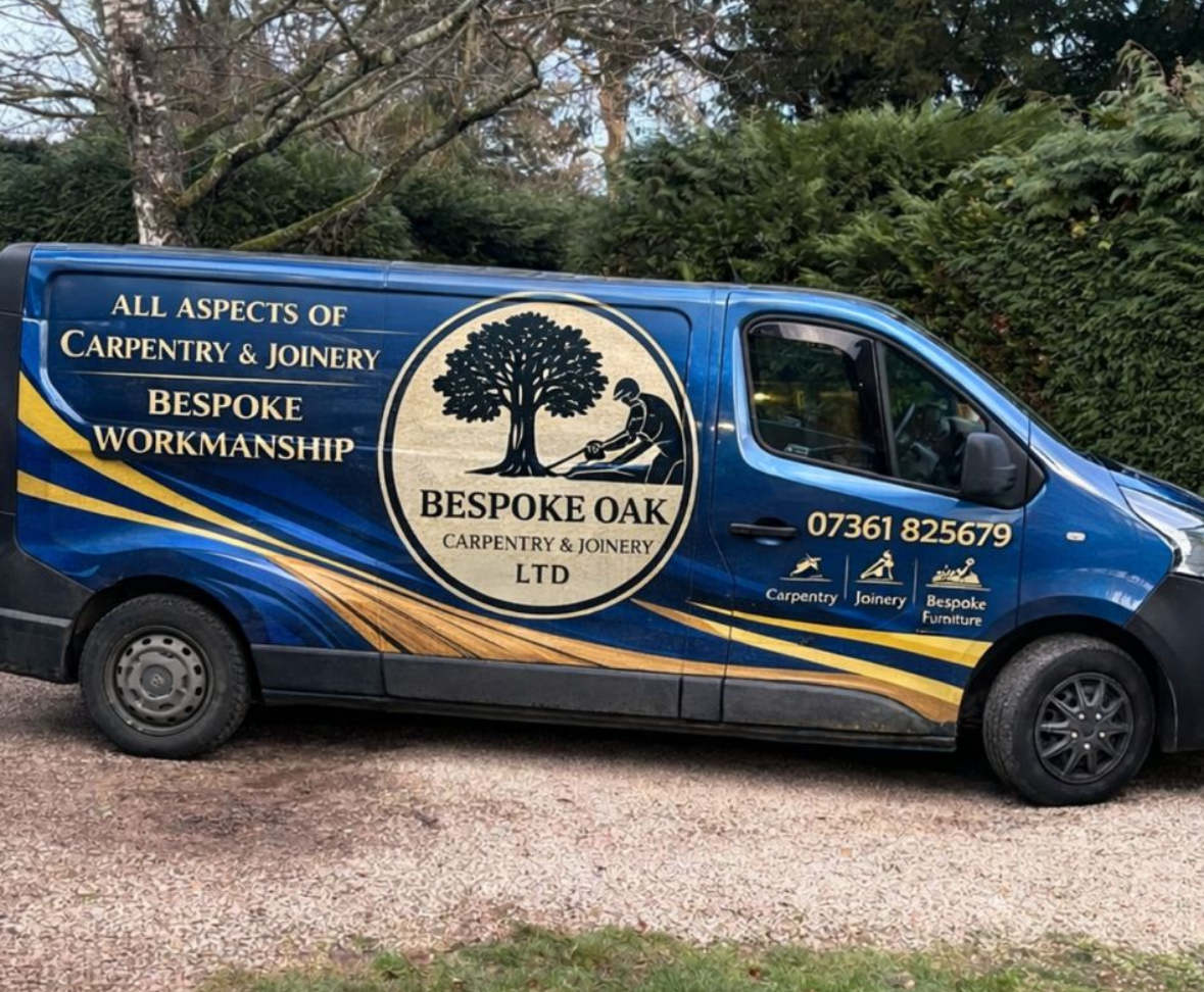 Blue company van for Bestoke Oak Carpentry & Joinery, showcasing services like carpentry, joinery, and bespoke furniture with contact number 07361 825679, parked on a gravel driveway with trees and greenery in the background.