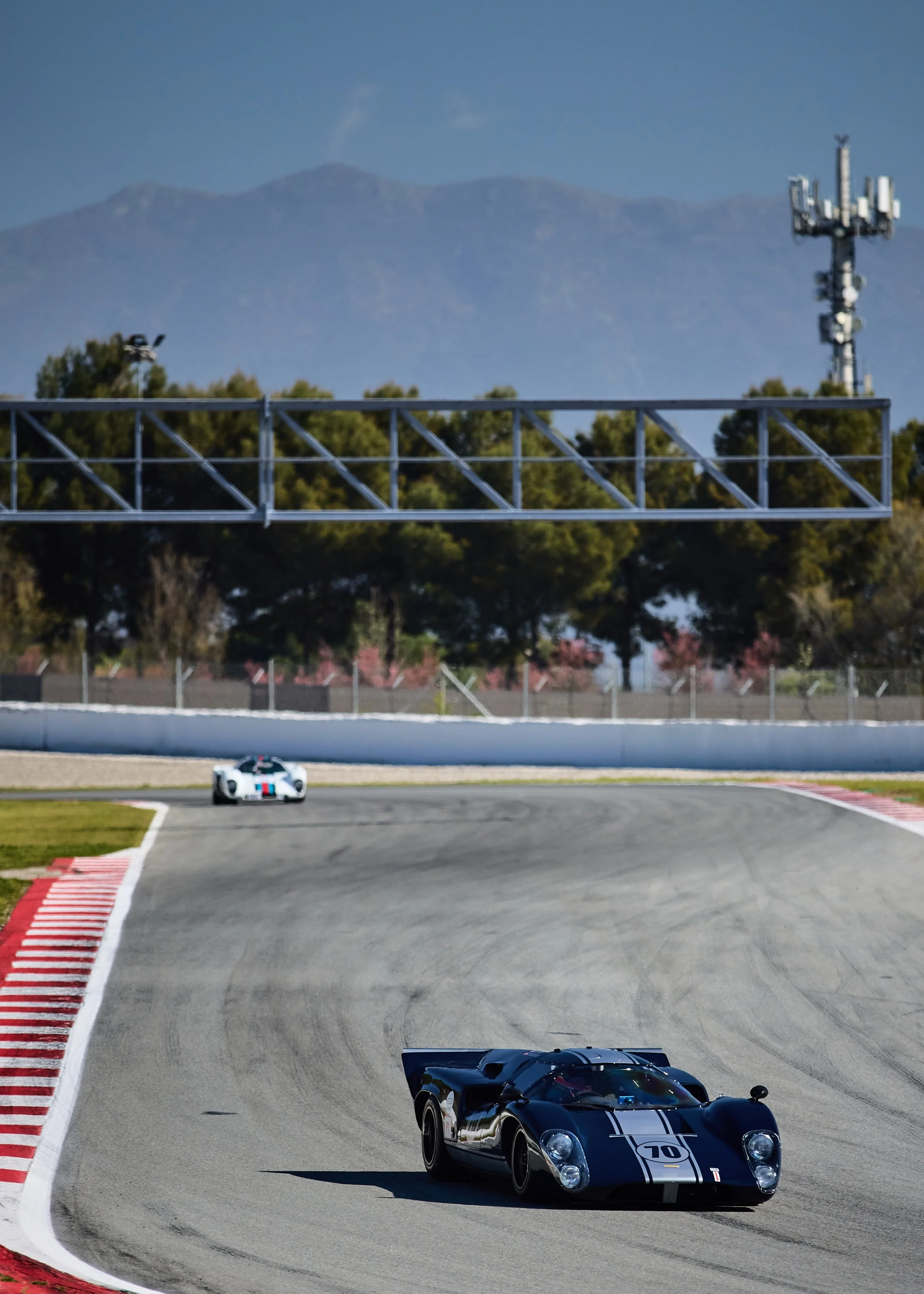 Car #70 leads through the infield, Montserrat in the distance.