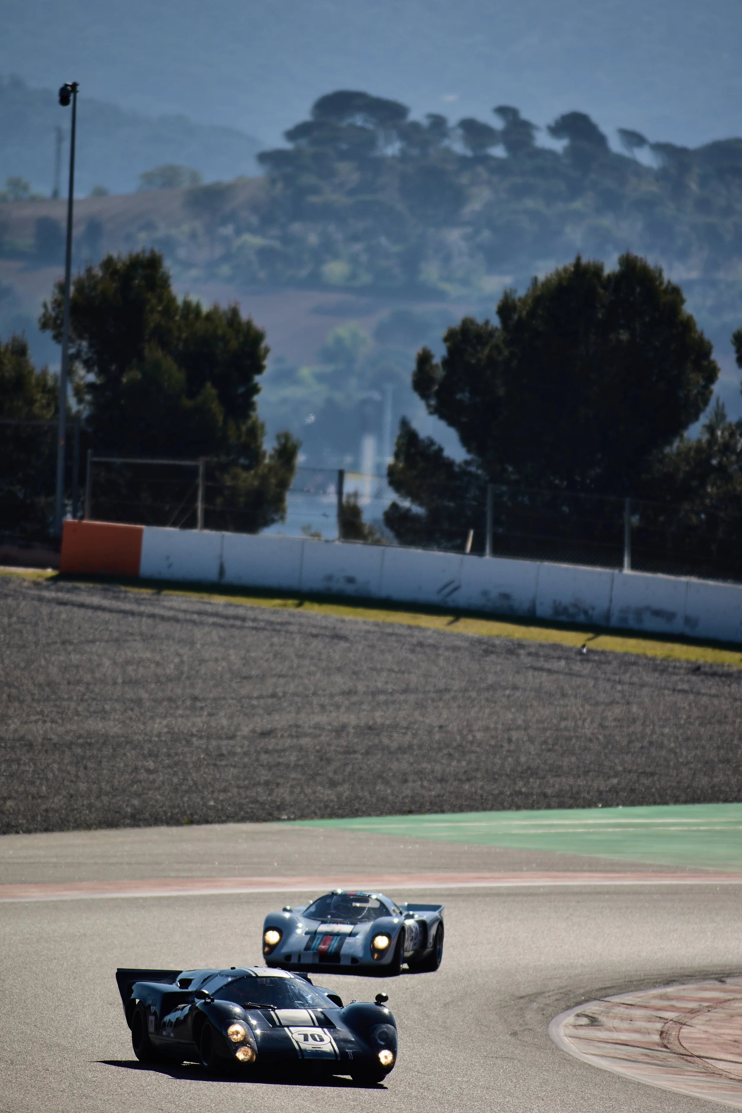 #70 leads into the infield. The Catalan hills behind.