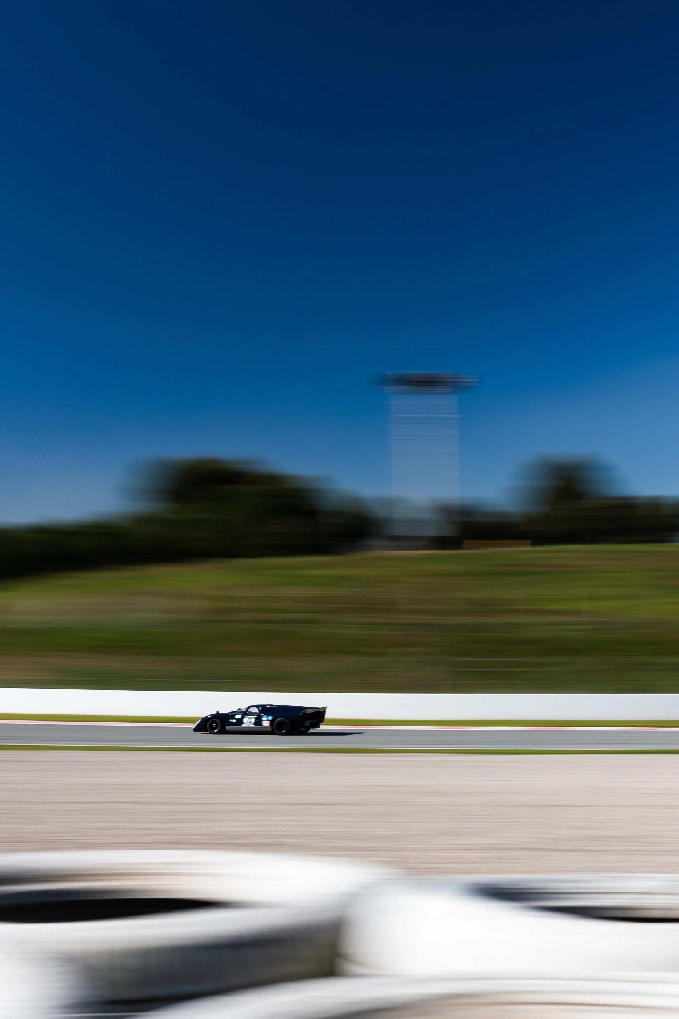 Flat out on the straight. The T70 against a Barcelona sky.