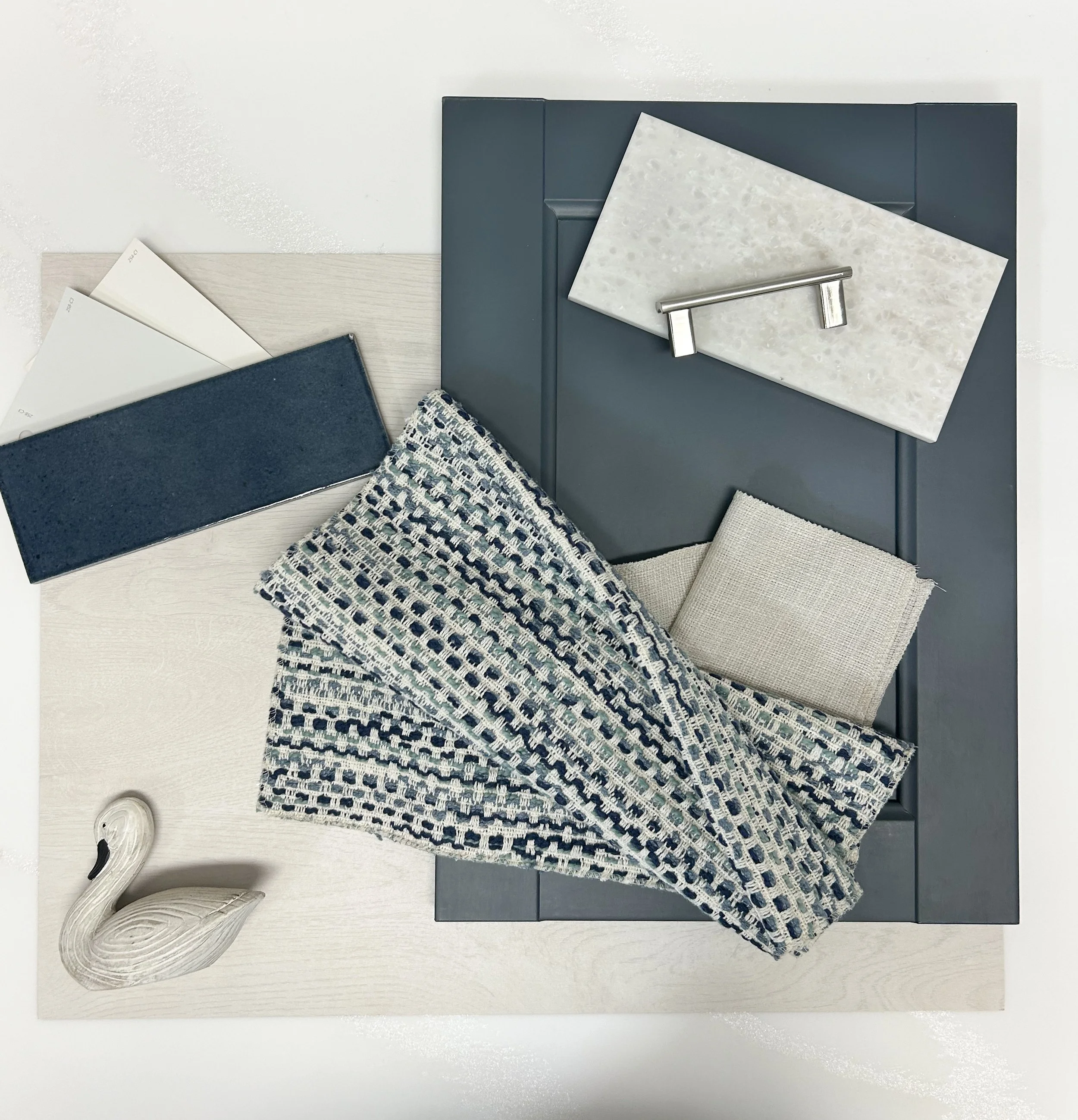 A flat lay designed to resemble a modern lake house vibe. Trying to stray away from beach house, I pulled darker blues and greens within the fabric. 