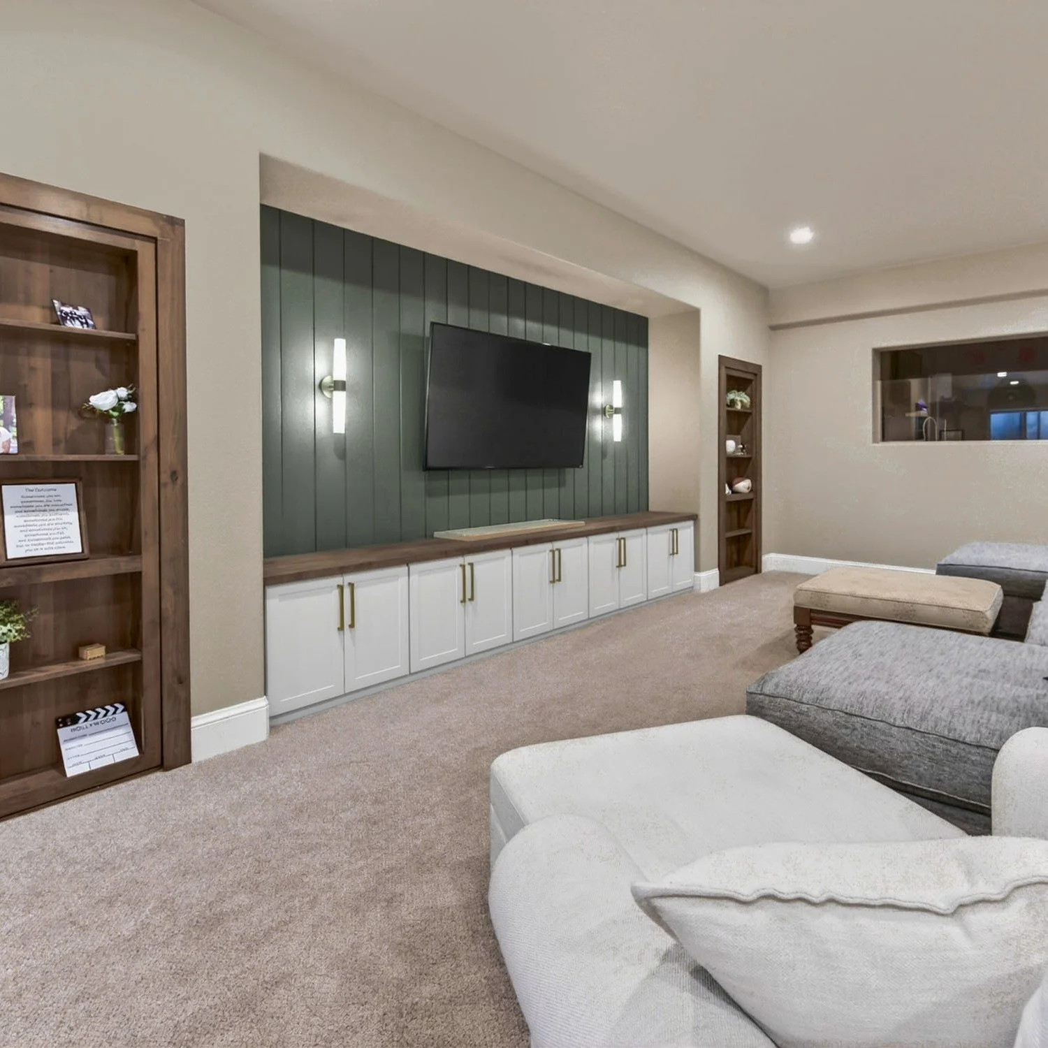 Sometimes a finished space just needs a designer's touch to make it feel more intentional. In this case, the already finished basement featured two smaller bedrooms that were being used for gym and game space, but that layout made the bottom of the s