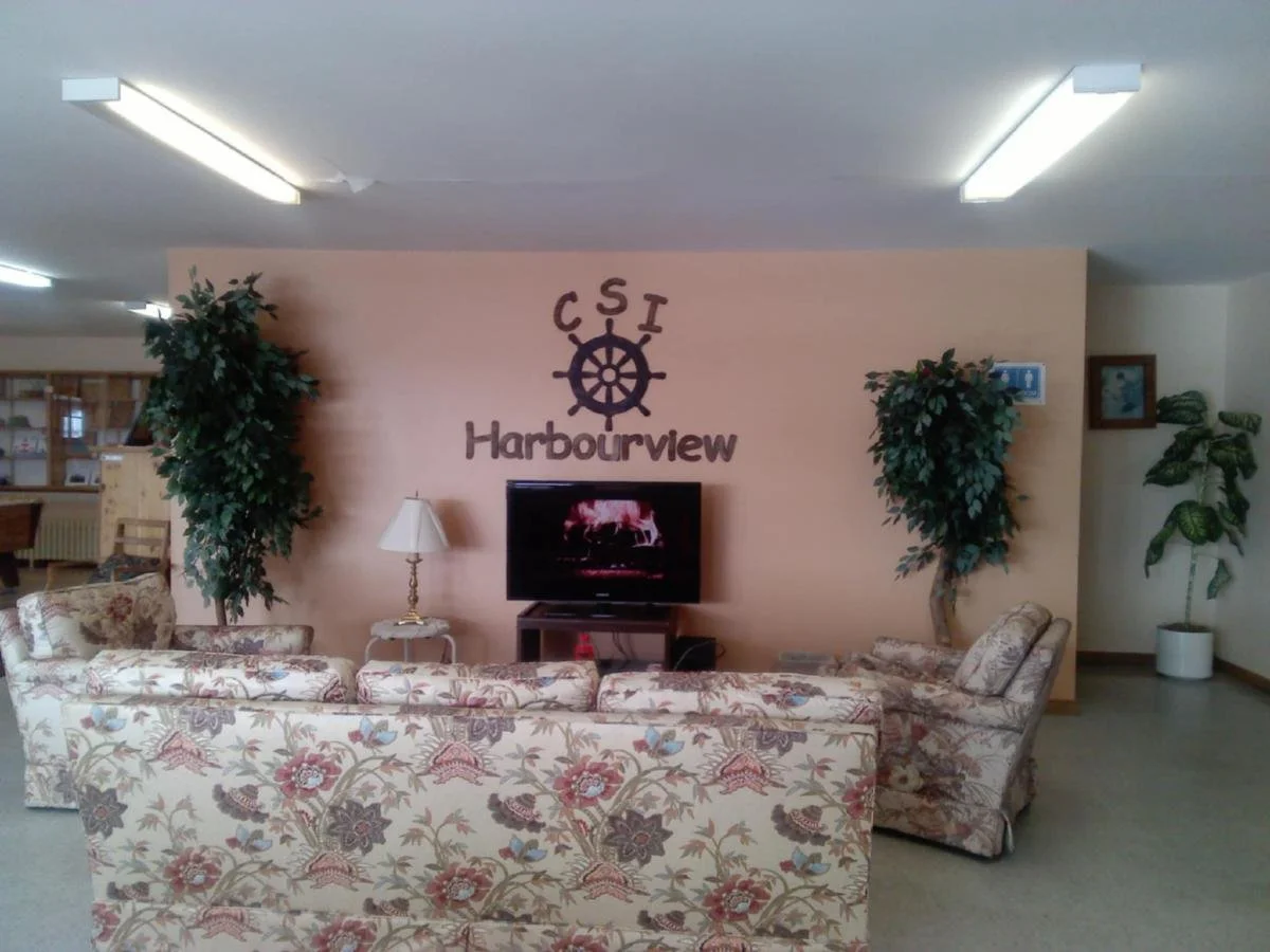 Inside the CSI Harbourview lobby with floral couches and indoor plants.