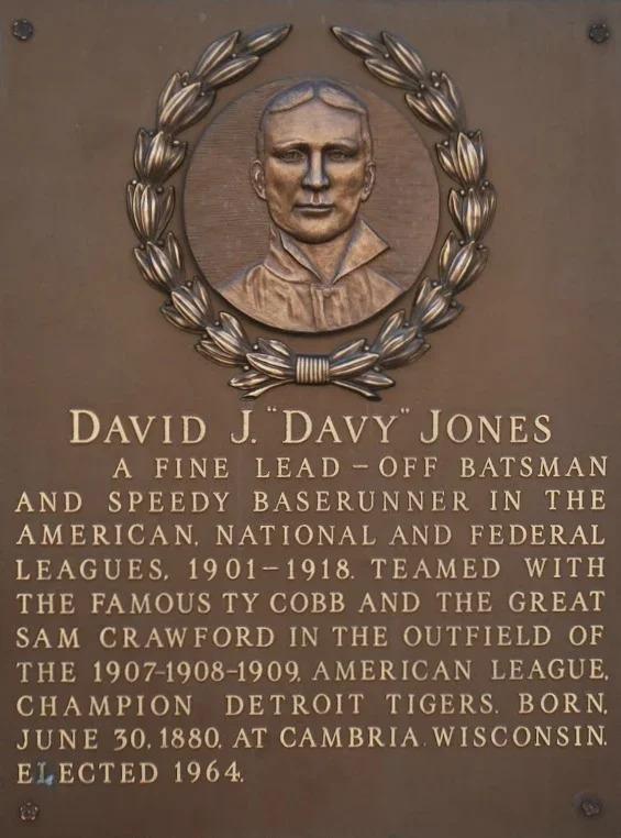 Plaque with a portrait of David J. 'Davy' Jones surrounded by a laurel wreath, describing his baseball career and background.