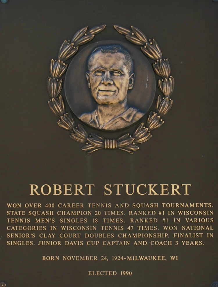 Plaque with a portrait of Robert Stuckert surrounded by a laurel wreath, detailing his tennis career achievements, birthplace Milwaukee WI, born November 24, 1924, elected in 1990.