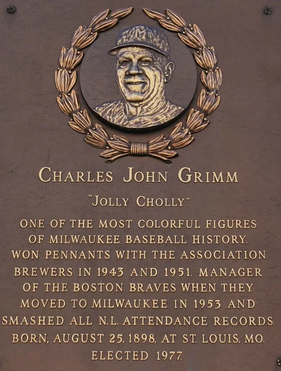 Bronze plaque and bust of Charles John Grimm, baseball player, with laurel wreath, with text describing his career and personal details.