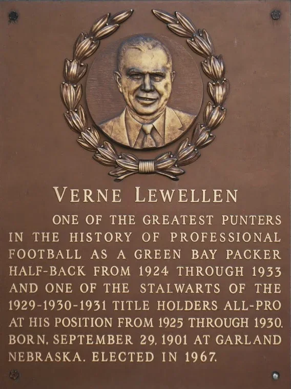 Plaque with a portrait of Verne Lewellen surrounded by a decorative wreath. Text describes Lewellen as a legendary football punter, half-back, and title holder from 1924 to 1933, born in 1901, and elected in 1967.