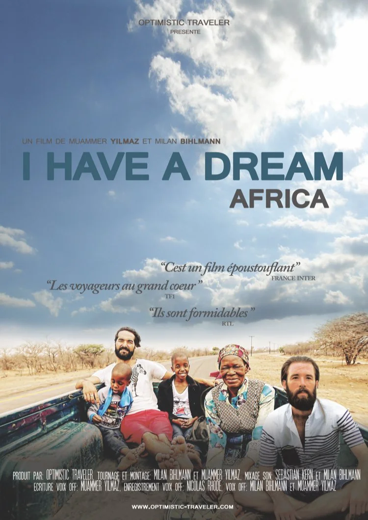Movie poster titled 'I Have a Dream Africa' showing a group of diverse people sitting in the back of a truck on a rural road, with a blue sky and clouds overhead.