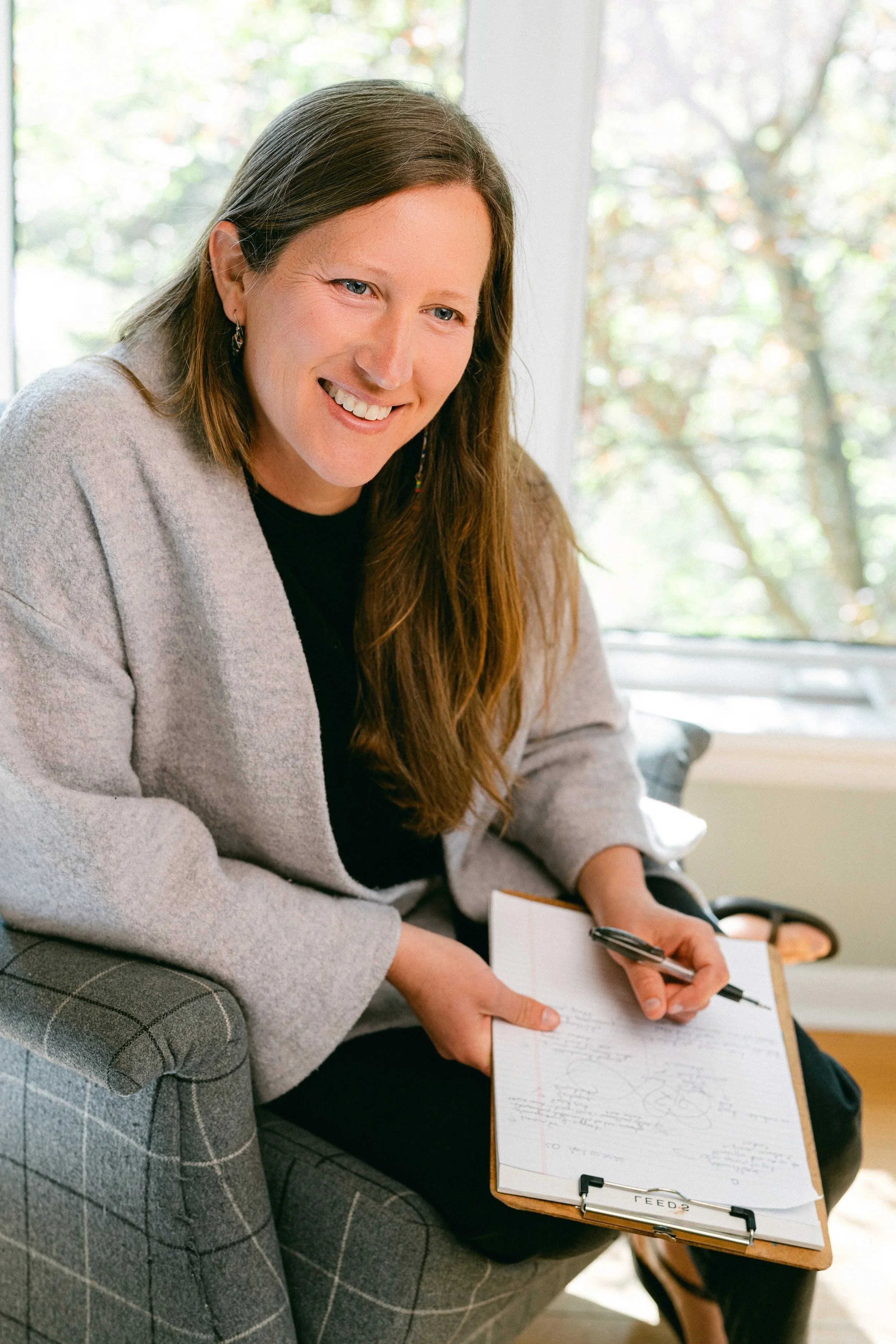 Jennifer Janssen with therapy diagrams on clipboard