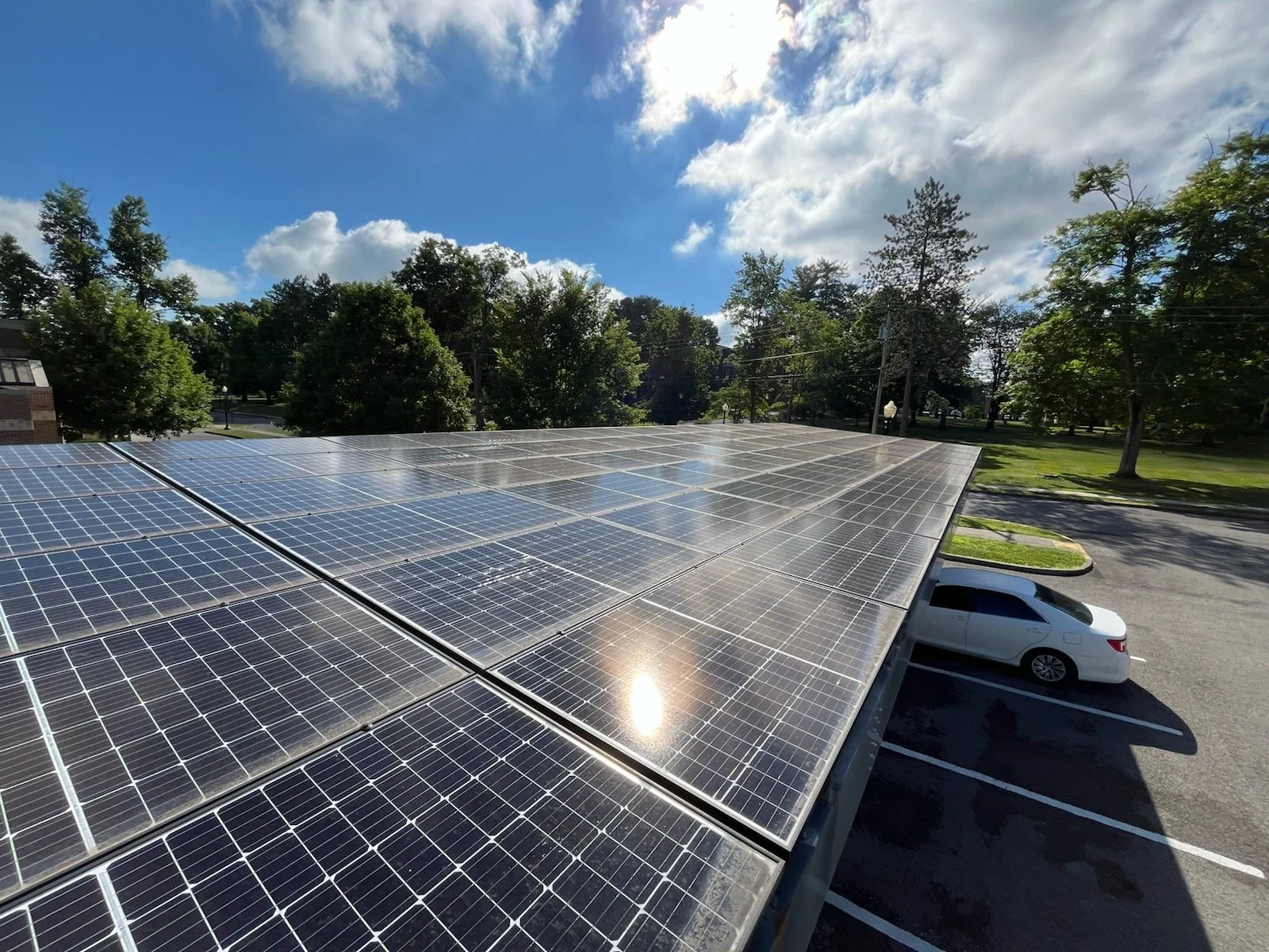 solar carport with a car parked beneath it on a sunny day