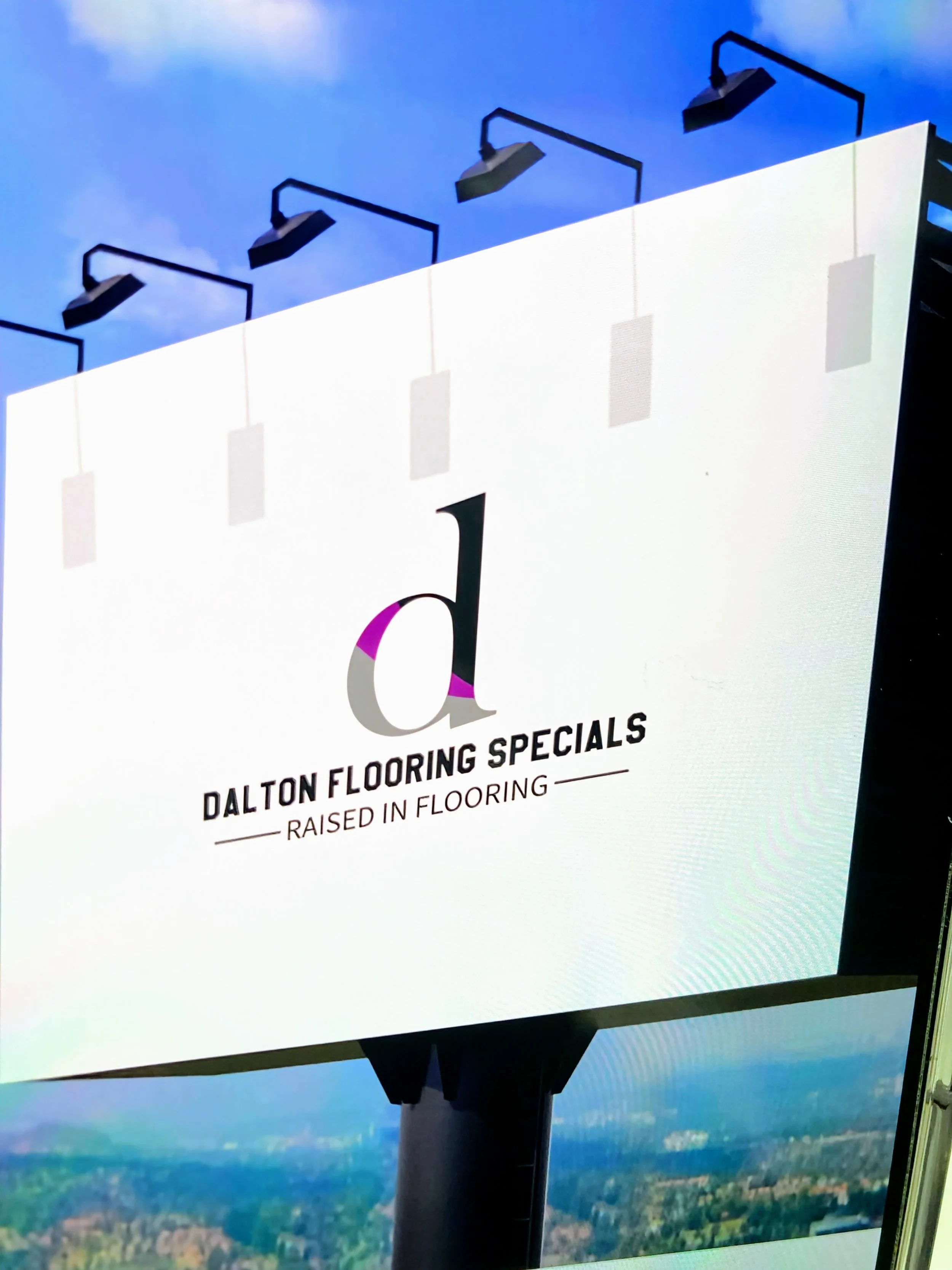 Billboard advertising Dalton Flooring Specials with the slogan "Raised in Flooring."