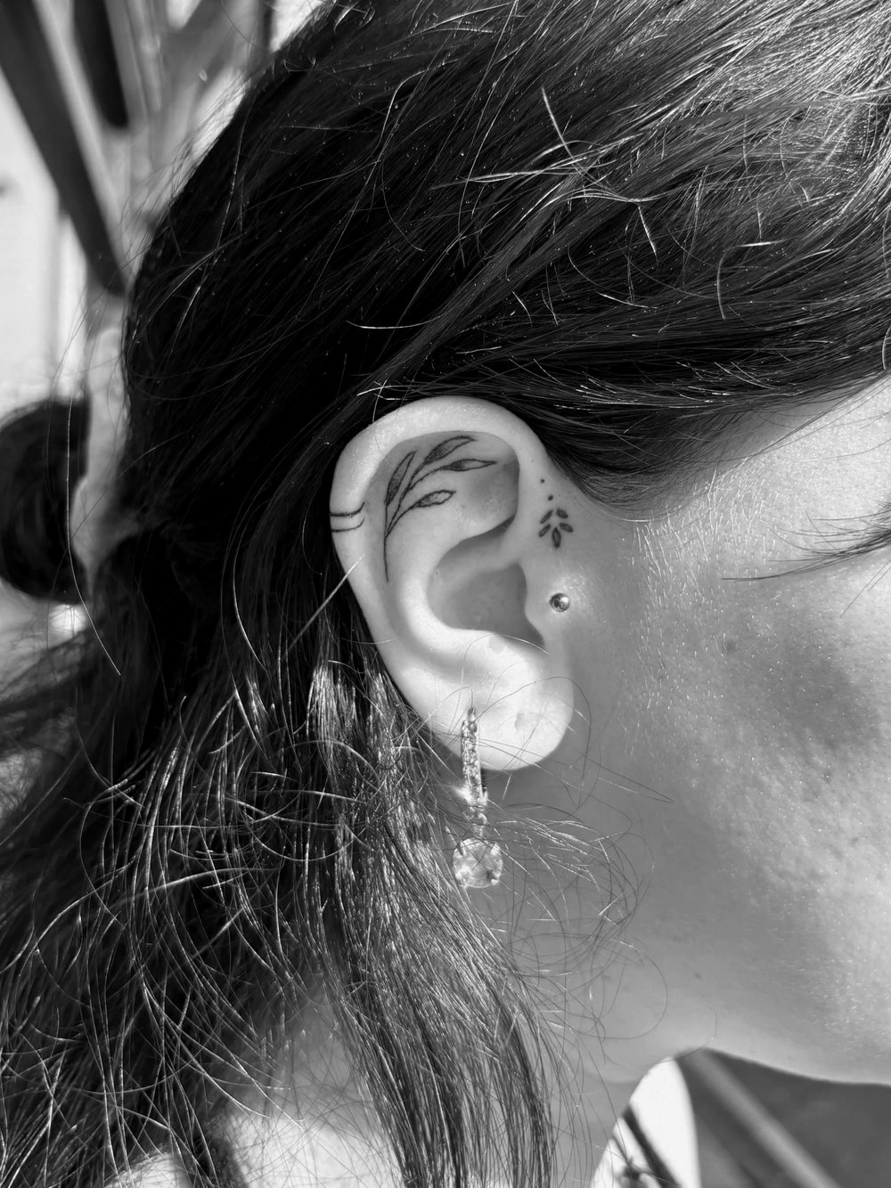 Small fine line ear tattoo