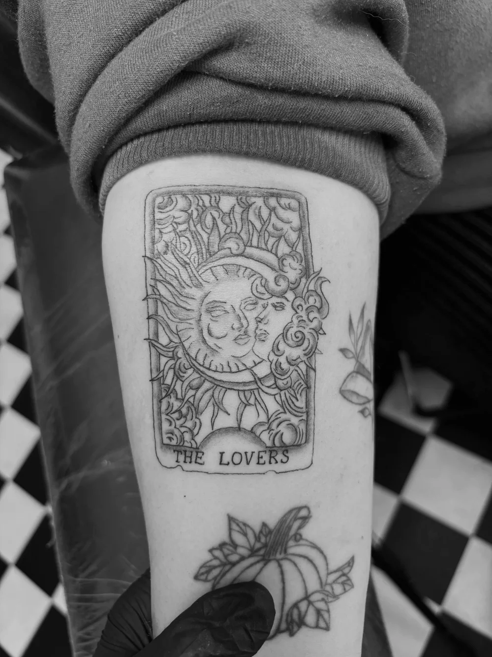 The Lovers tarot card tattoo on an upper arm