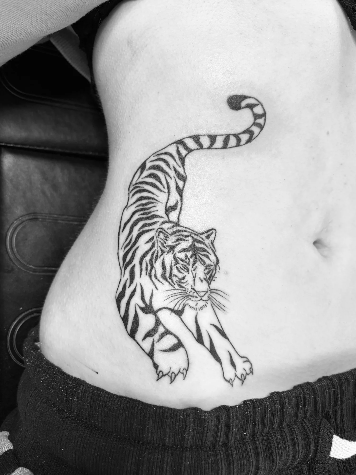 Fine line tiger tattoo on the hip