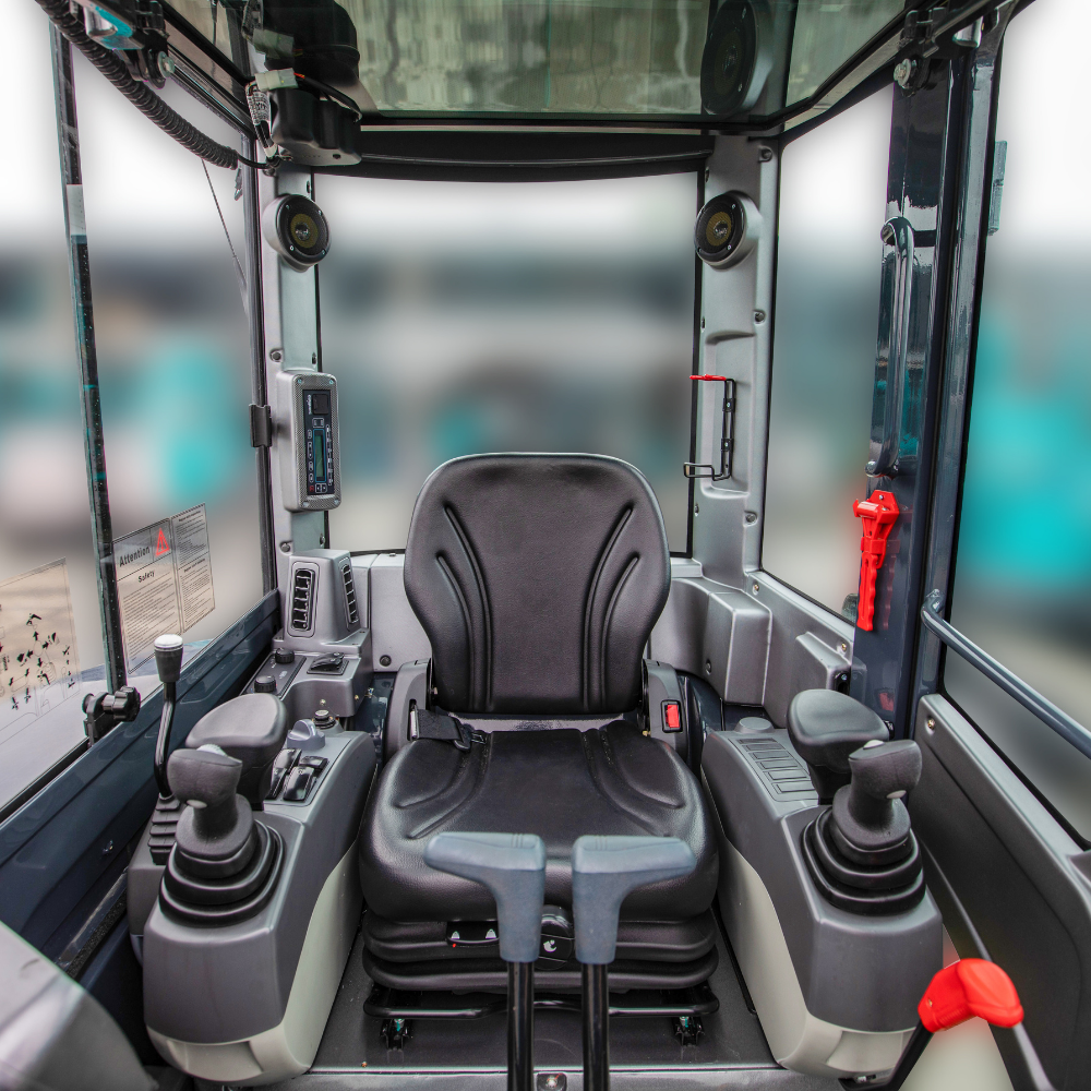 Inside view of a Sunward mini excavator cab with a black driver's seat, control joysticks, and various electronic controls.