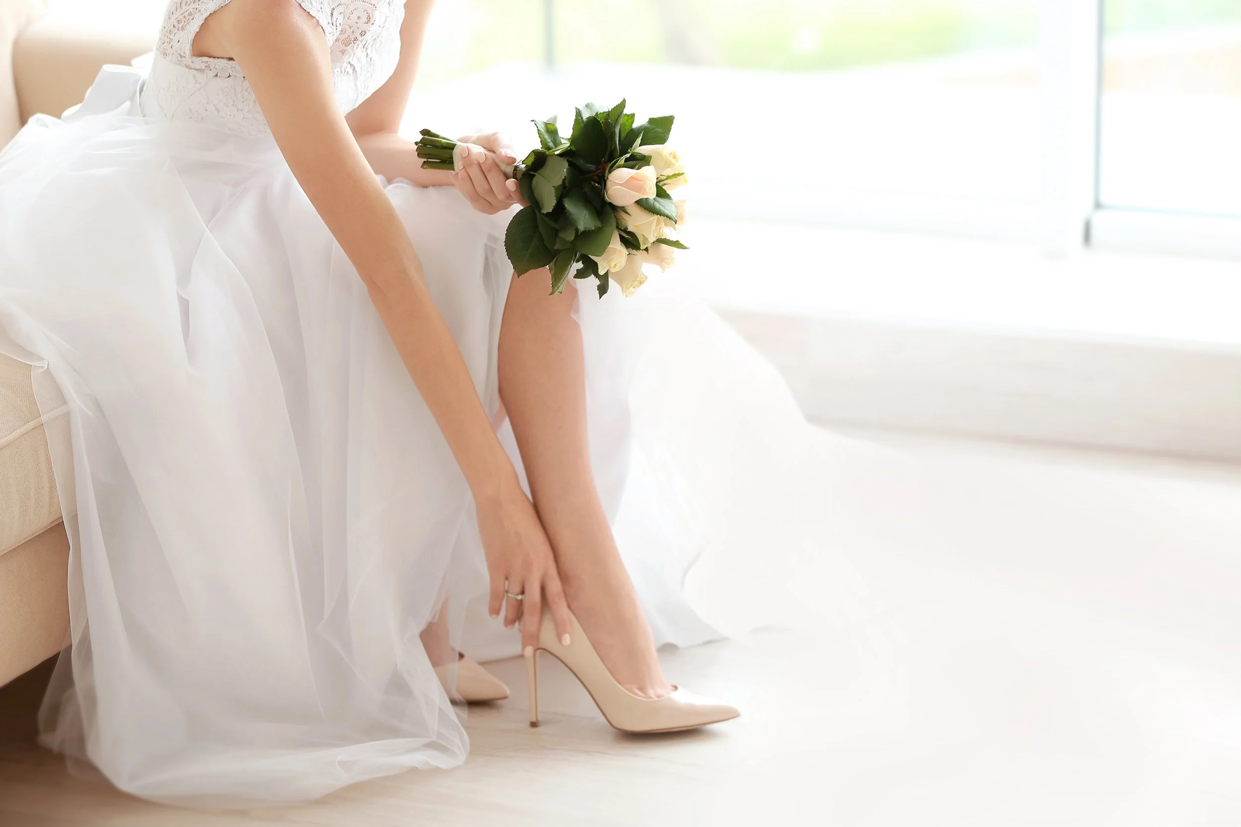 Bridal fitting appointment with tailor making precise gown adjustments in Marstons Mills, MA