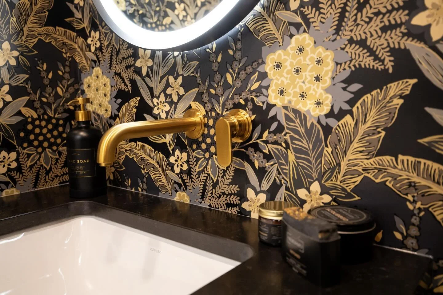 Powder rooms are where we love to create drama and go bold! Our showroom bathroom is exactly that! 

We wanted to make a statement in the powder room and nothing is better than a bold moody wallpaper paired with the Riobel Arca wall-mounted faucet in