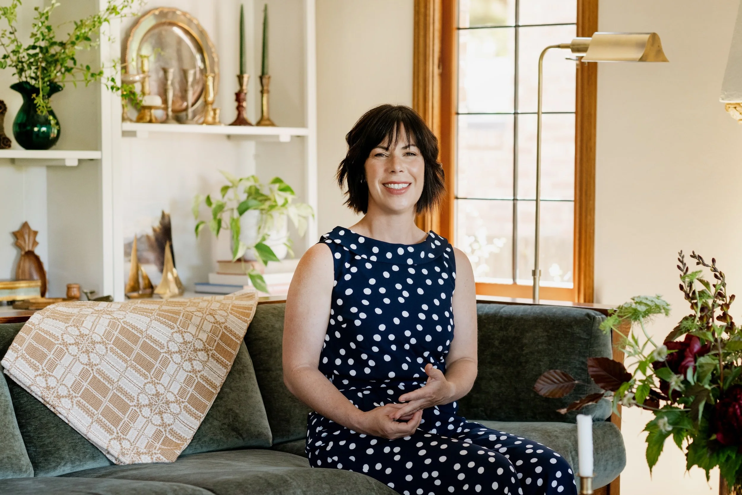 Rebecca Letwin, Principal Designer of Full Bloom Interior Design, in a professionally styled Seattle living room.