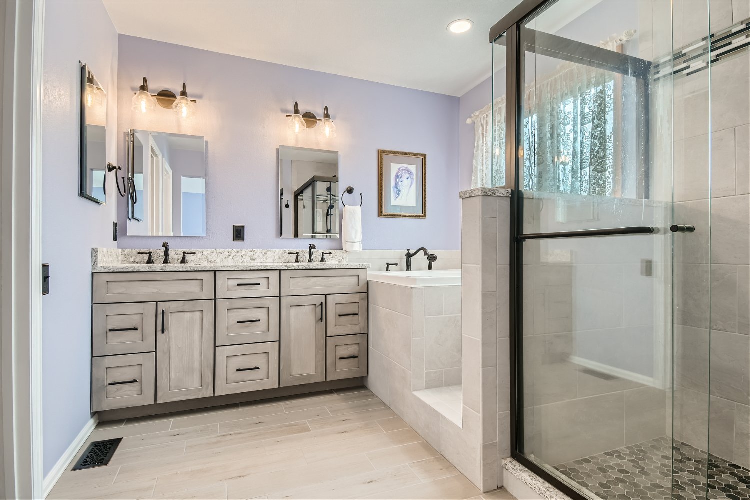 Modern bathroom with double vanity, granite countertop, wall-mounted mirrors, black fixtures, a built-in bathtub, and a glass-enclosed shower with tiles.