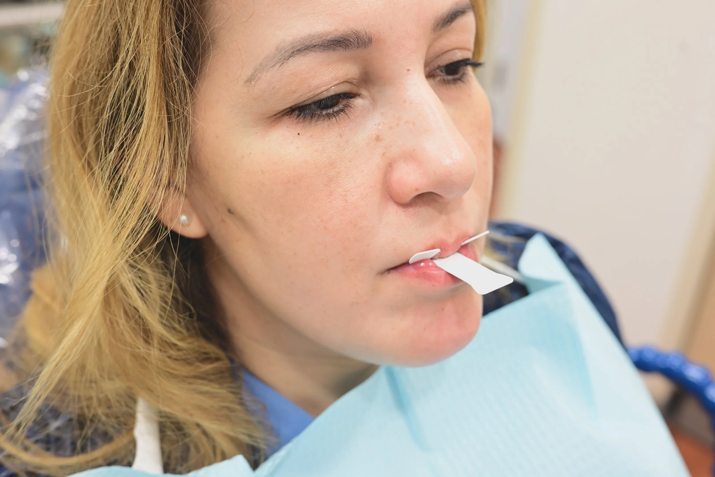 A woman during FishburneTab evaluation in dental office.