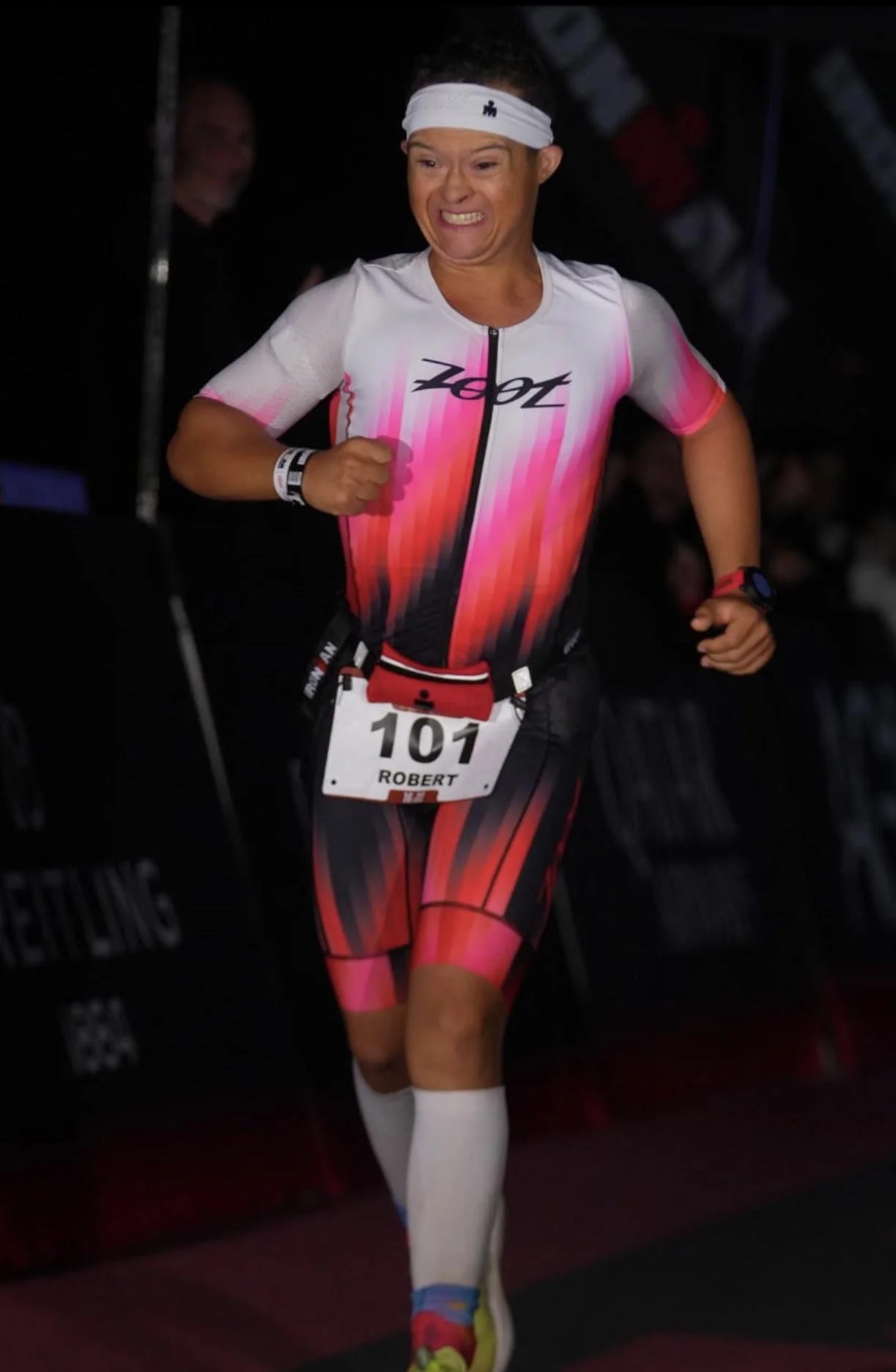 Robert Norris, Man of Iron, running toward the finish line at IRONMAN Arizona.