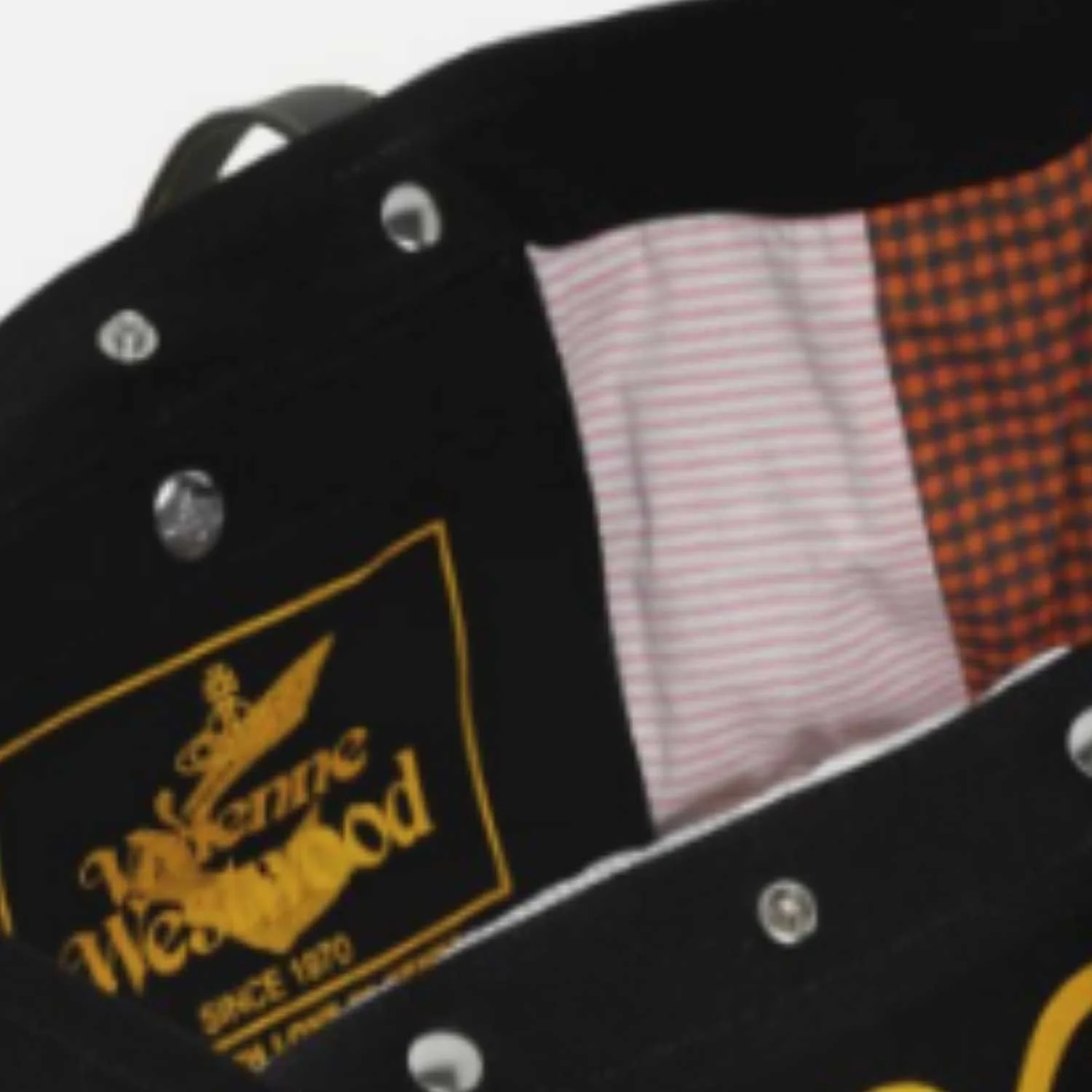 Close-up of an upcycled tote bag with a yellow and black patch manufactured by Beyond Remade for global fashion brand Vivienne Westwood.