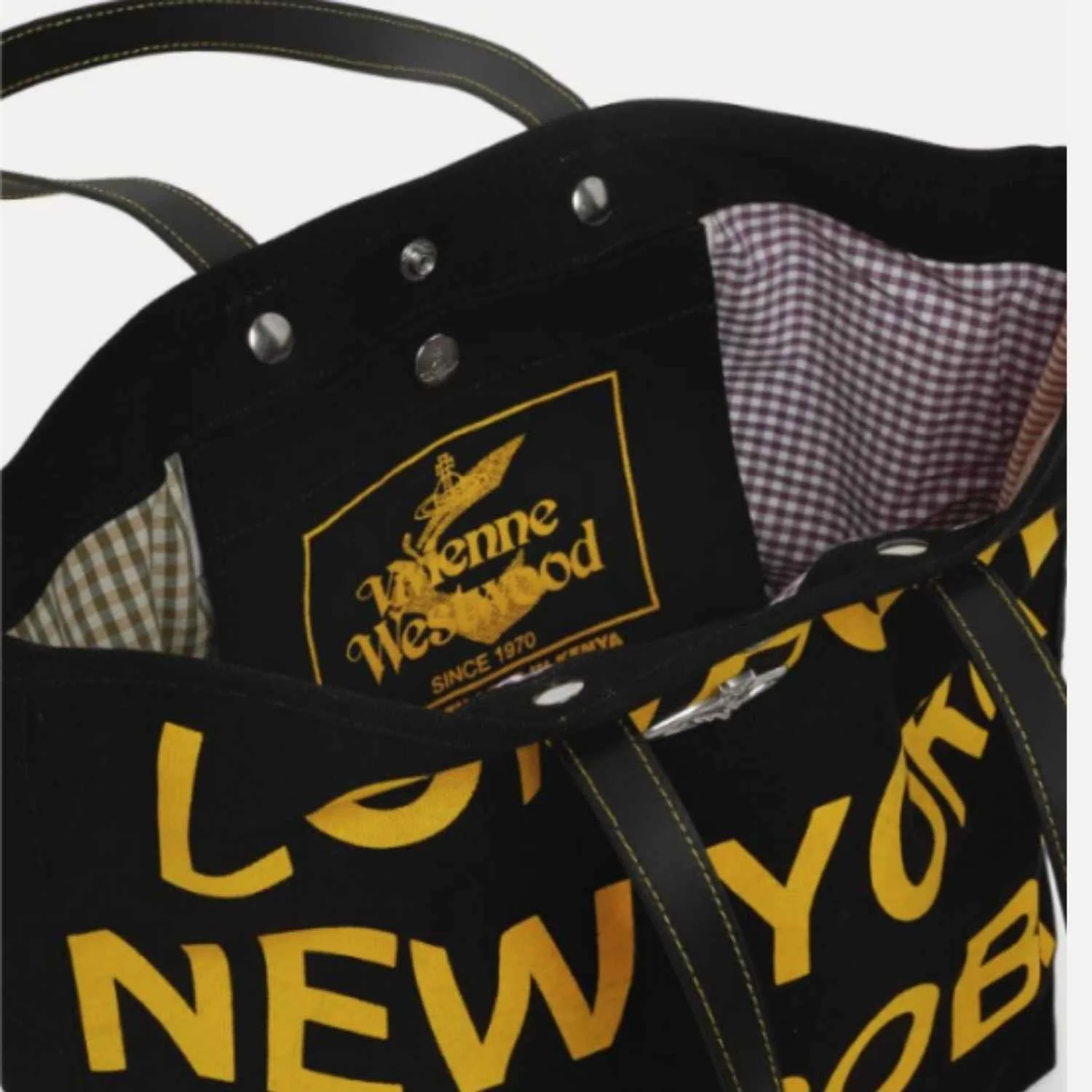 Close-up of an upcycled tote bag with a yellow and black patch manufactured by Beyond Remade for global fashion brand Vivienne Westwood.