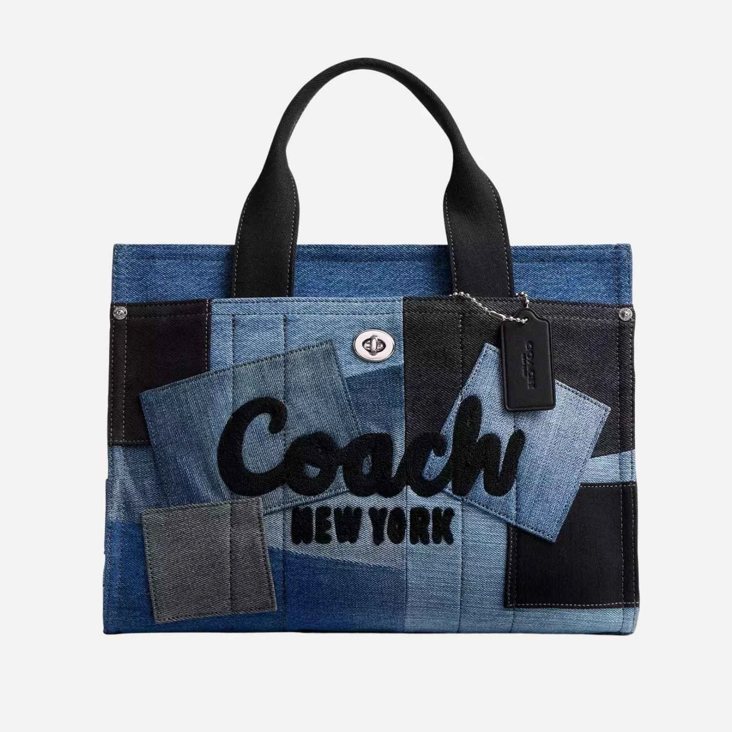 A Coach handbag made from patchwork denim with the words 'Coach New York' embroidered on the front.