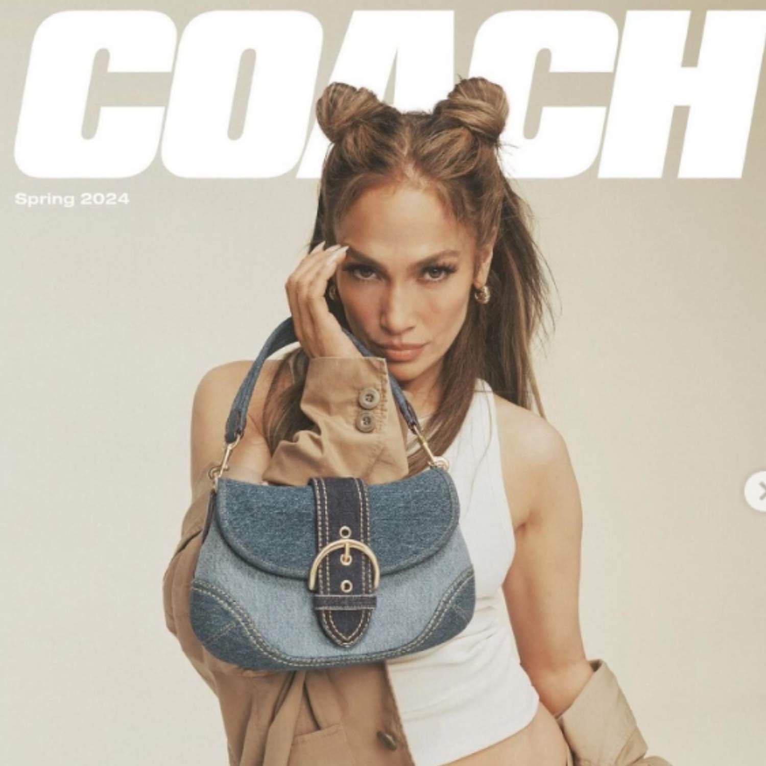 Fashion magazine cover featuring the signer and actress Jennifer Lopez holding upcycled handbag manufactured by Beyond Remade for the global fashion brand Coach.