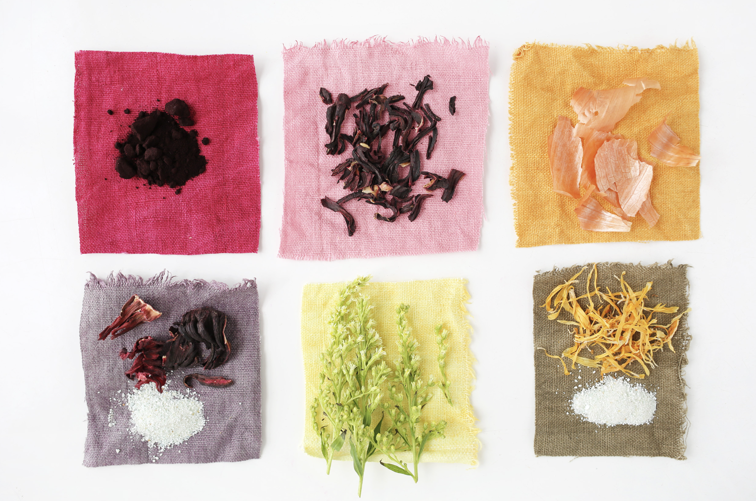 Six colorful fabric squares, each with different dried herbs or spices arranged on top, on a white background. The fabrics are red, pink, orange, purple, yellow, and brown.