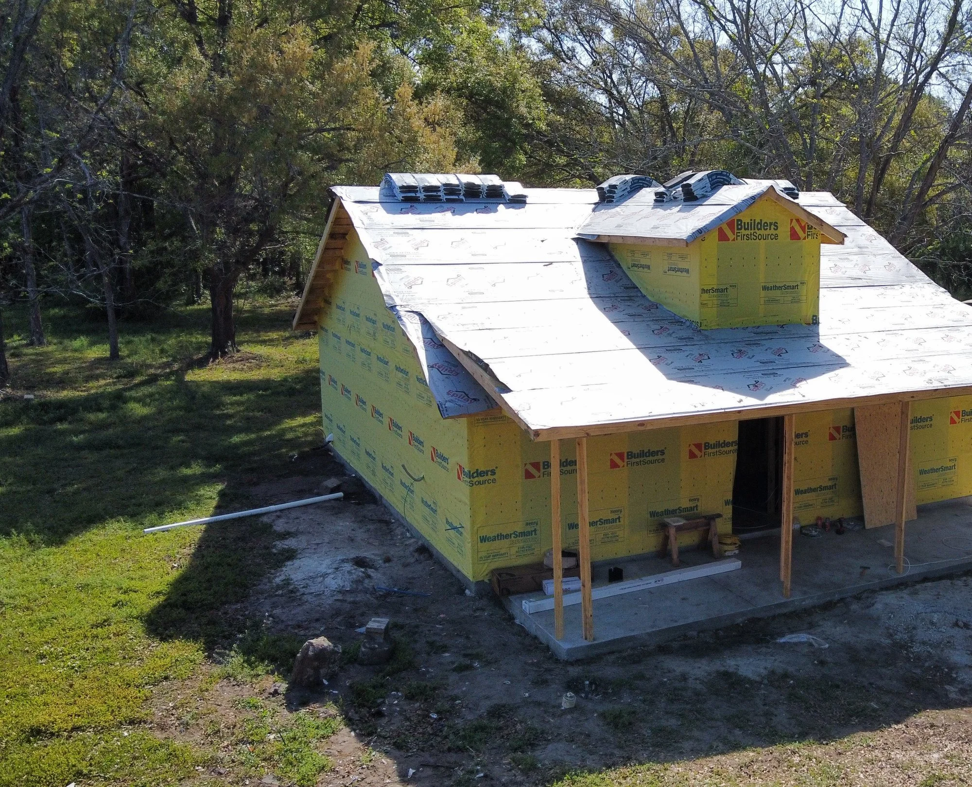 Aerial view of new construction with roof underlayment and weather-resistant wrap installed