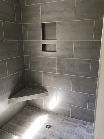 01-finished-gray-tiled-shower-with-bench-and-niches.jpeg