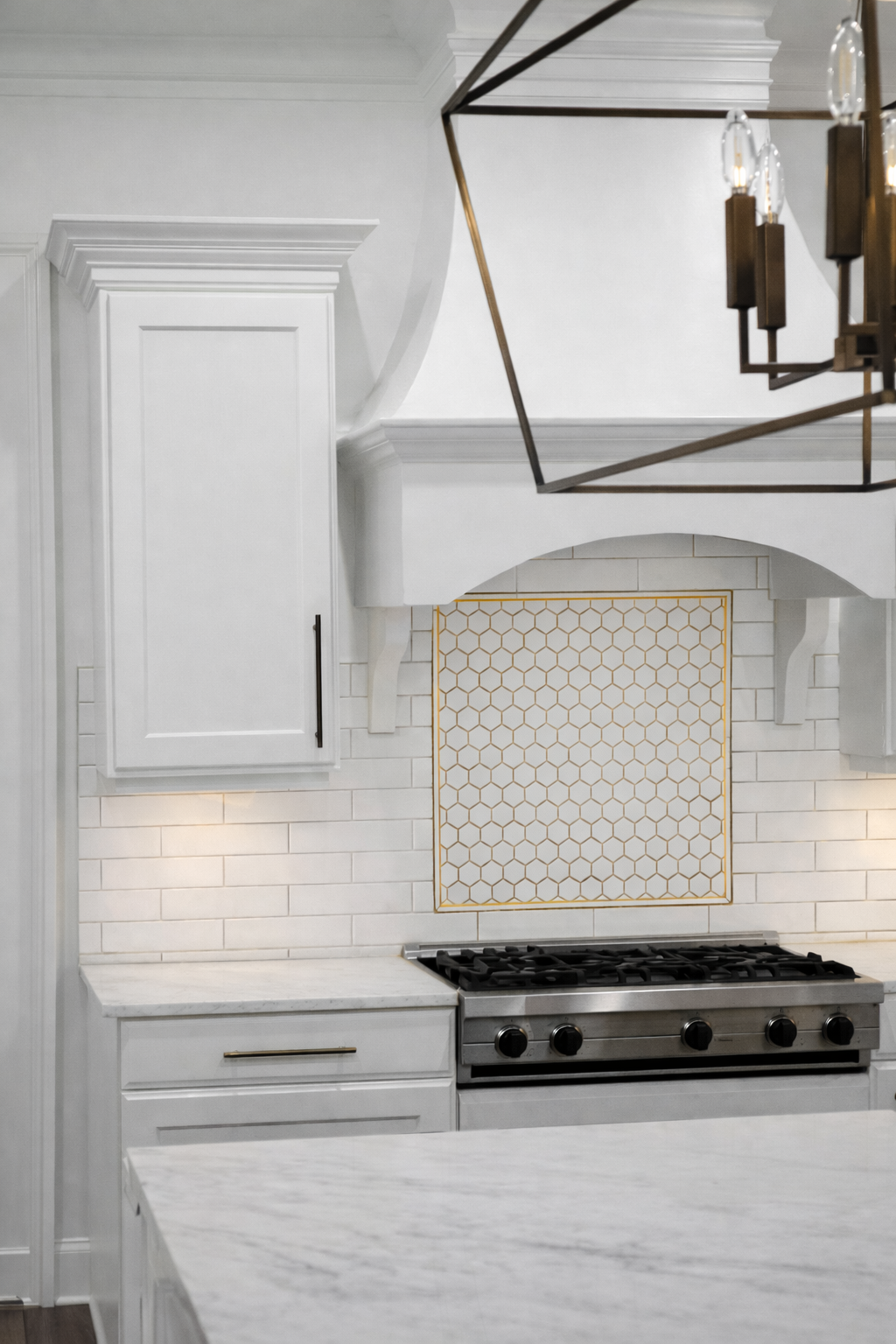 Modern kitchen with white cabinetry, tile backsplash, and clean functional finishes completed by Wilken Precision Remodeling.
