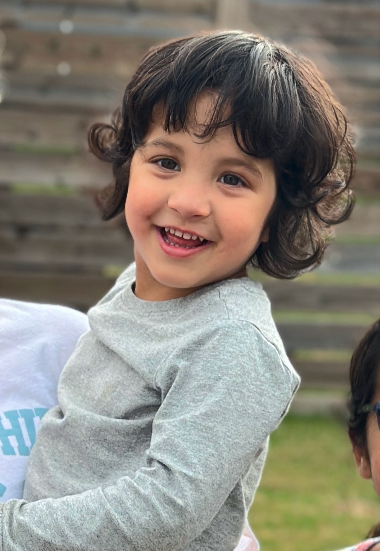 Cute little boy with brown eyes smiling at camera