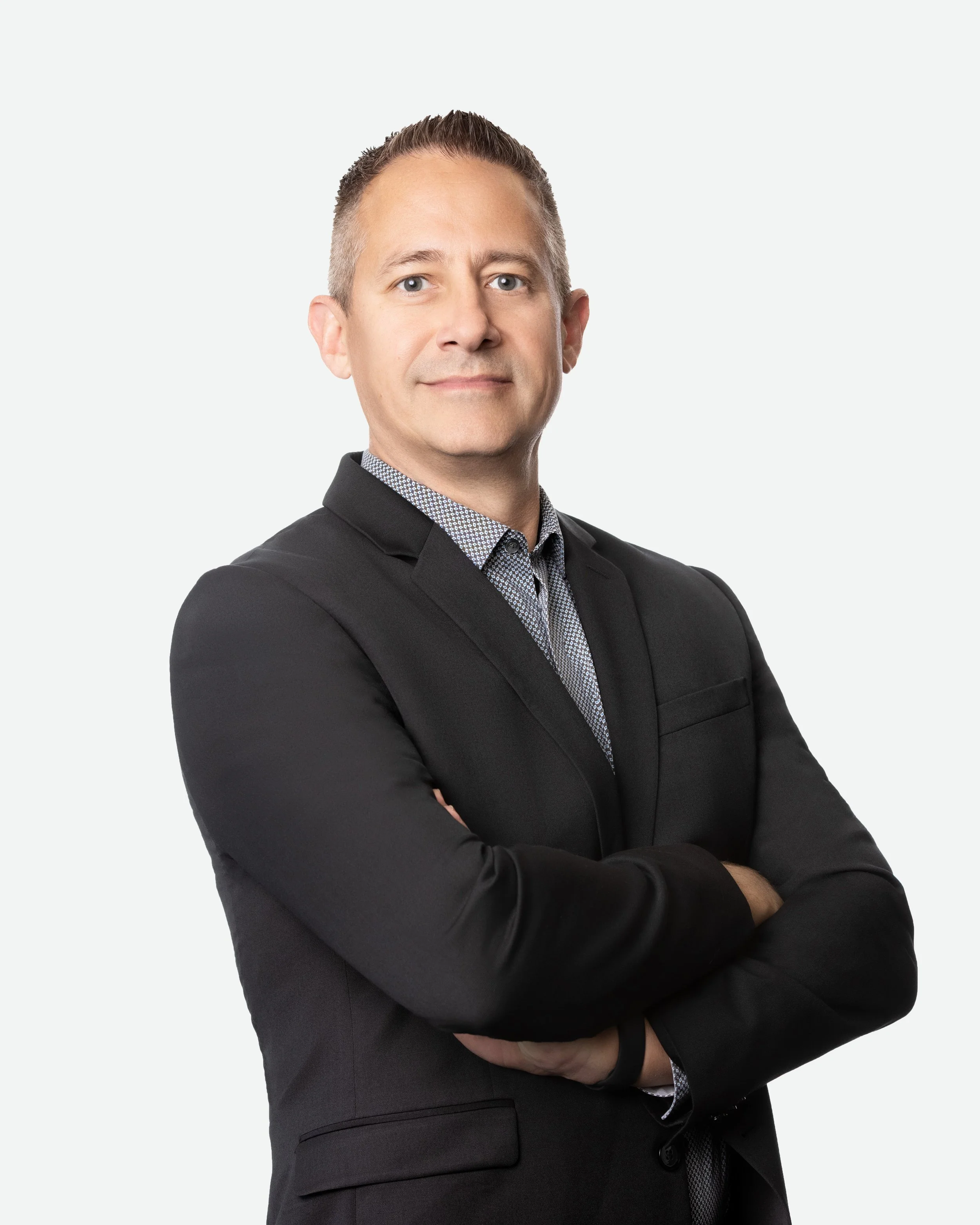 Headshot of confident man with crossed arms