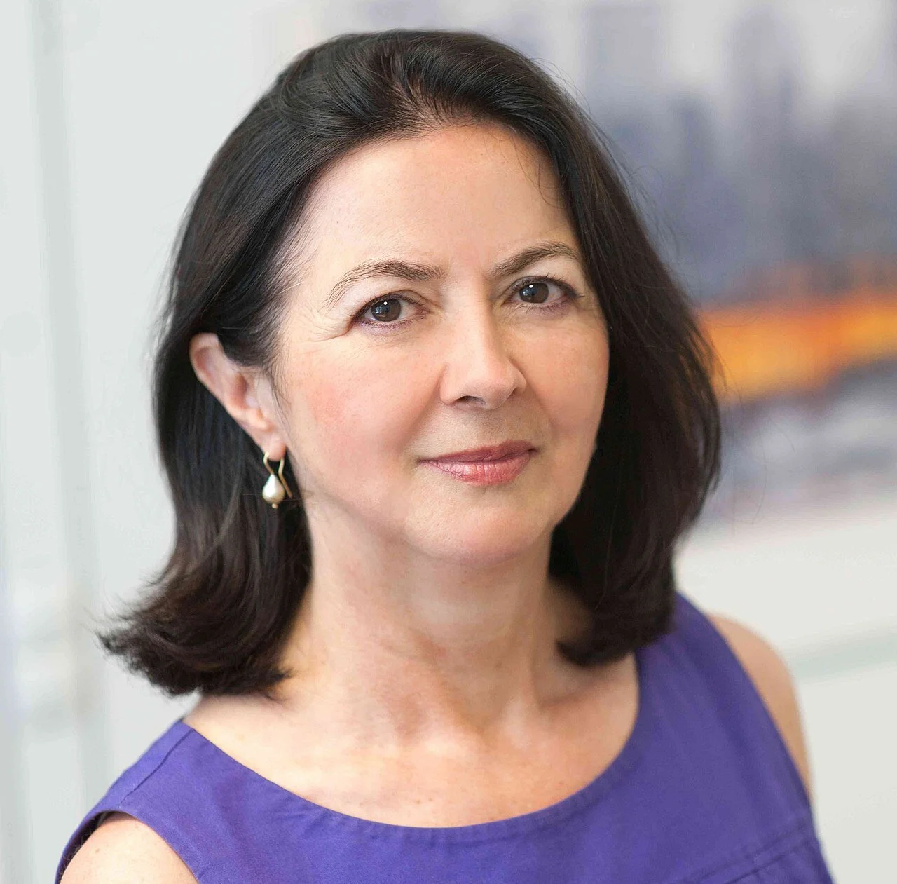 Headshot of woman with short dark hair and pearl earring