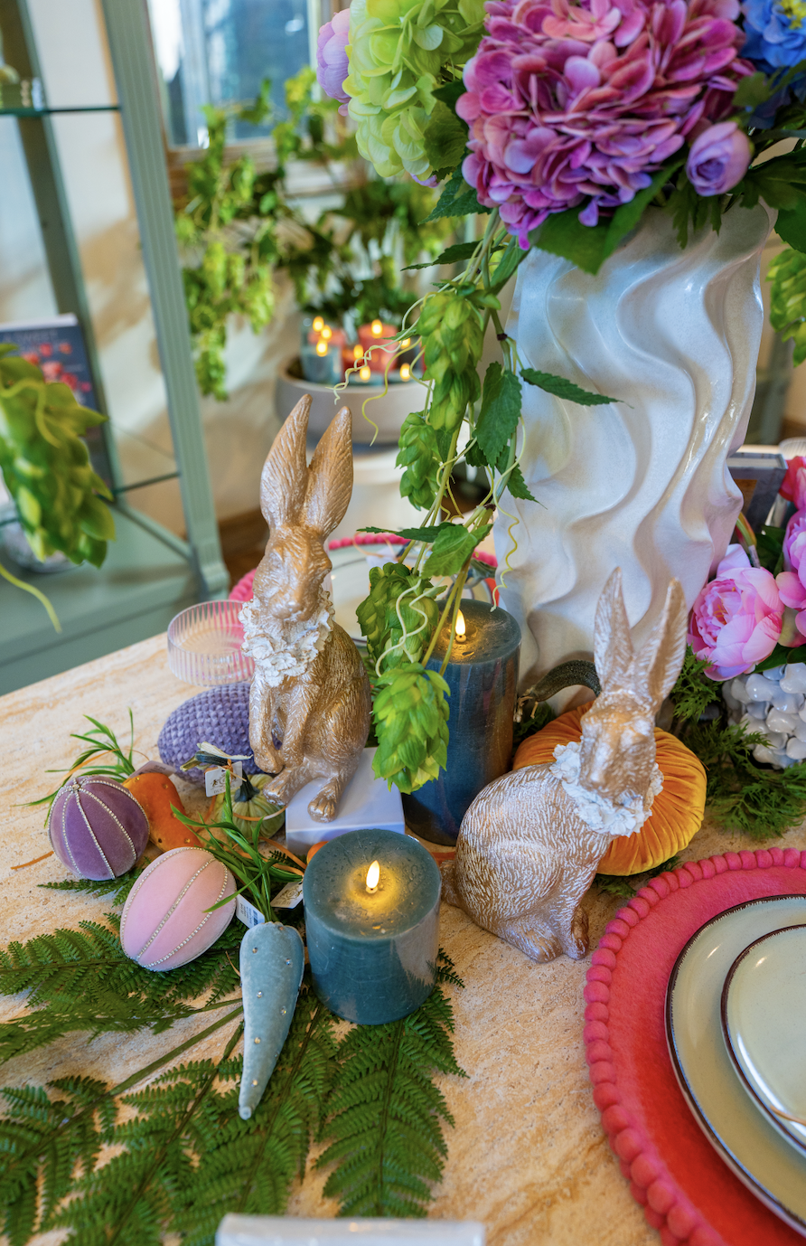Seasonal home décor display at The Duchess by NM Designs featuring layered tabletop styling, colorful florals, decorative seasonal items, candles, and curated entertaining décor in Old Towne Orange, California.