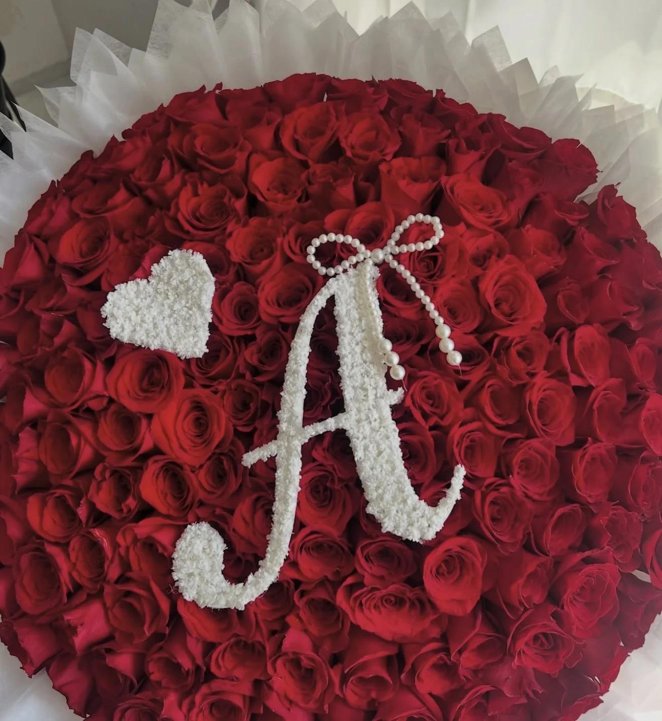 100 roses, floral letter, floral heart, cotton filler, and pearl bow