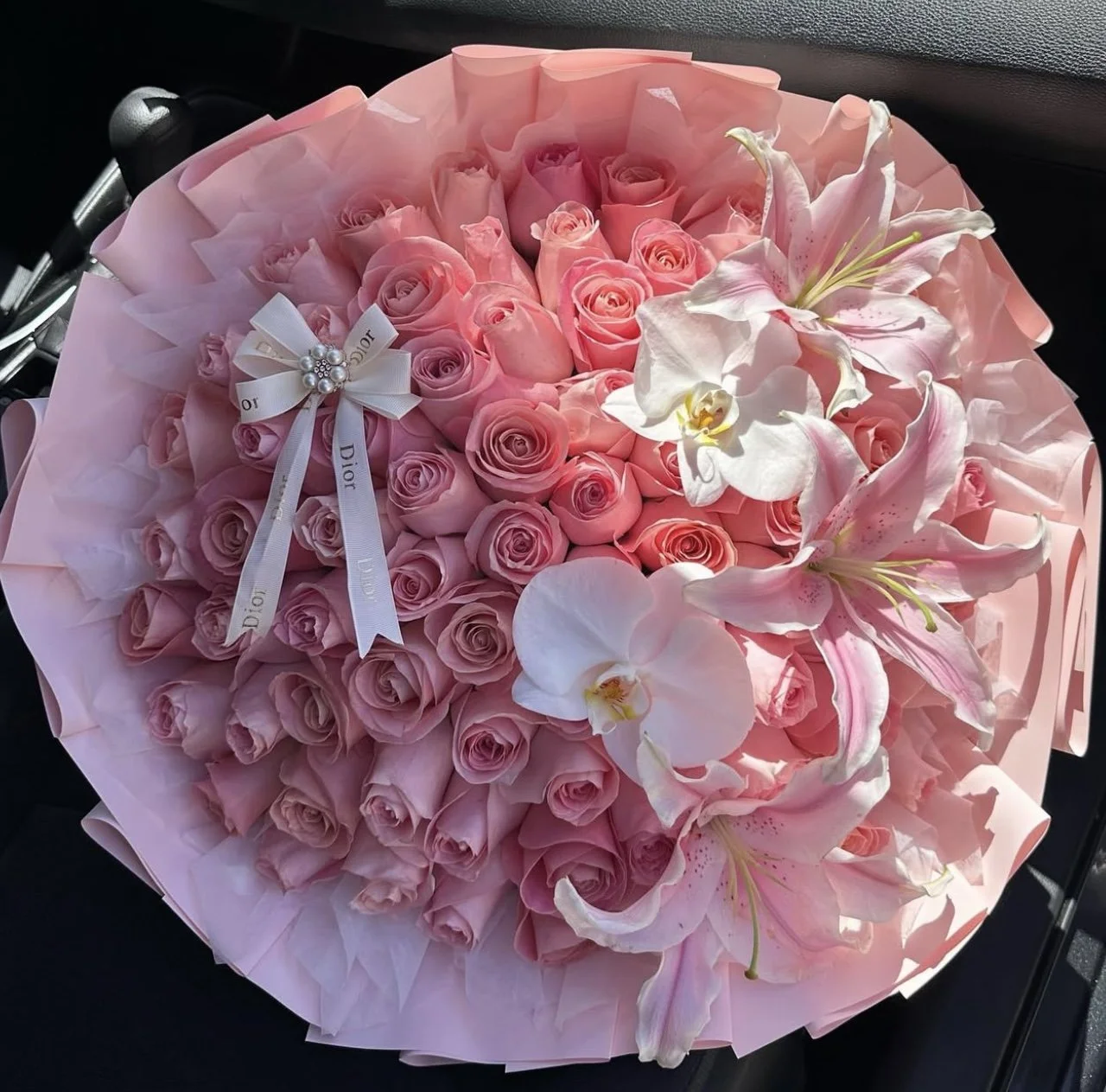 50 roses, lilies, orchids, bow, cotton filler, with korean style wrap.