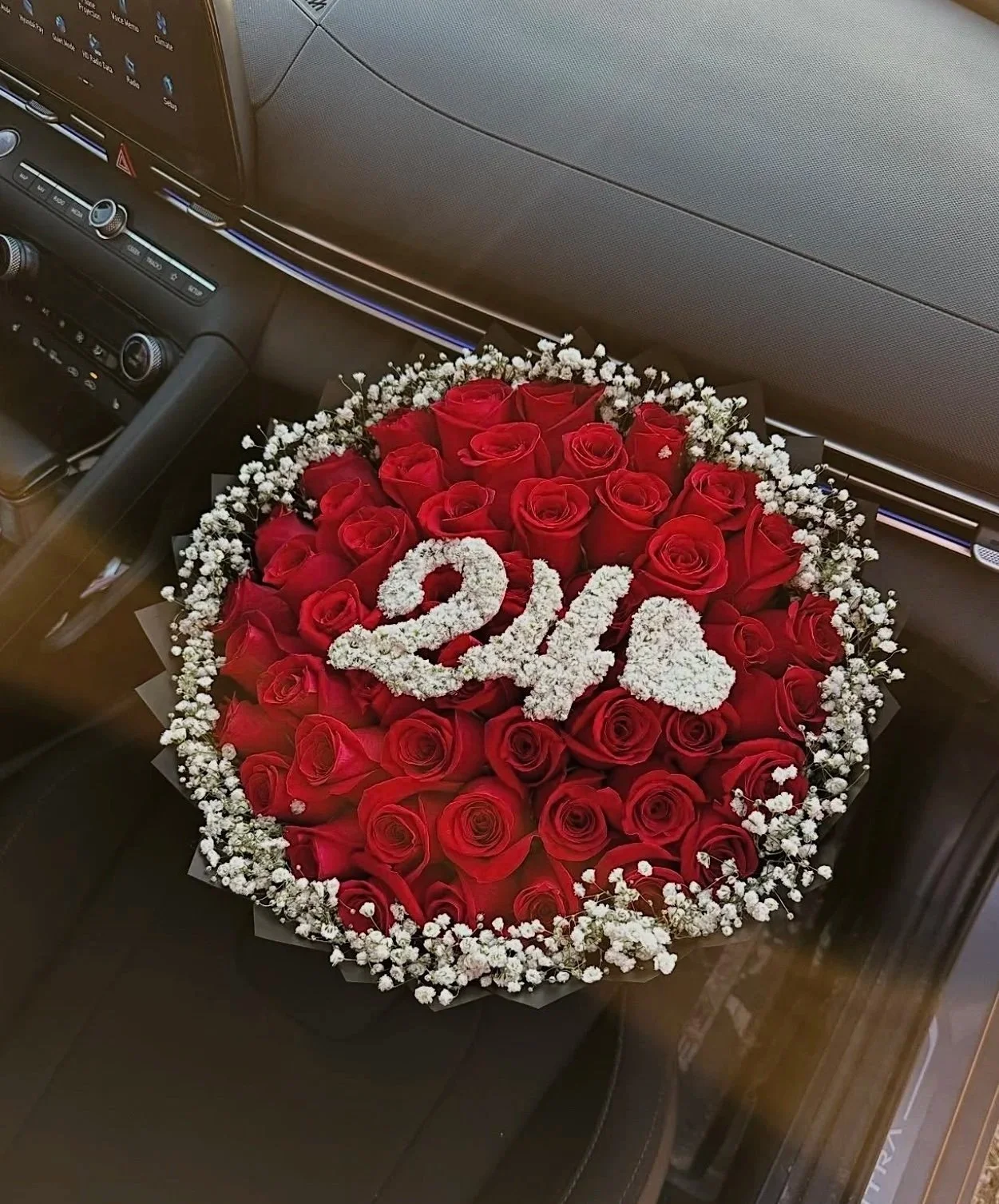50 roses, Baby breath rim, two floral numbers and heart.