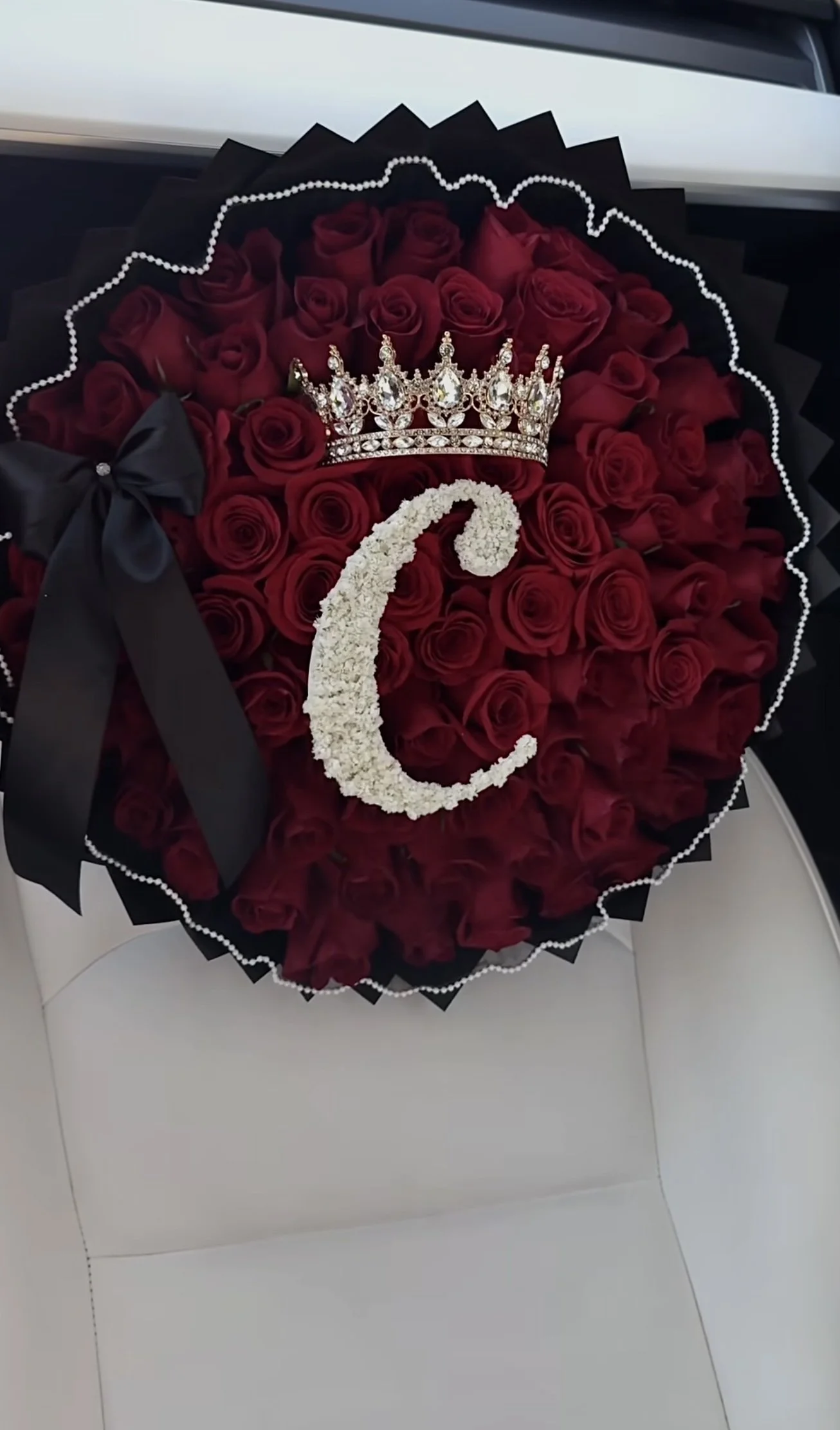 75 roses, floral letter, pearl liner, bow, and large crown